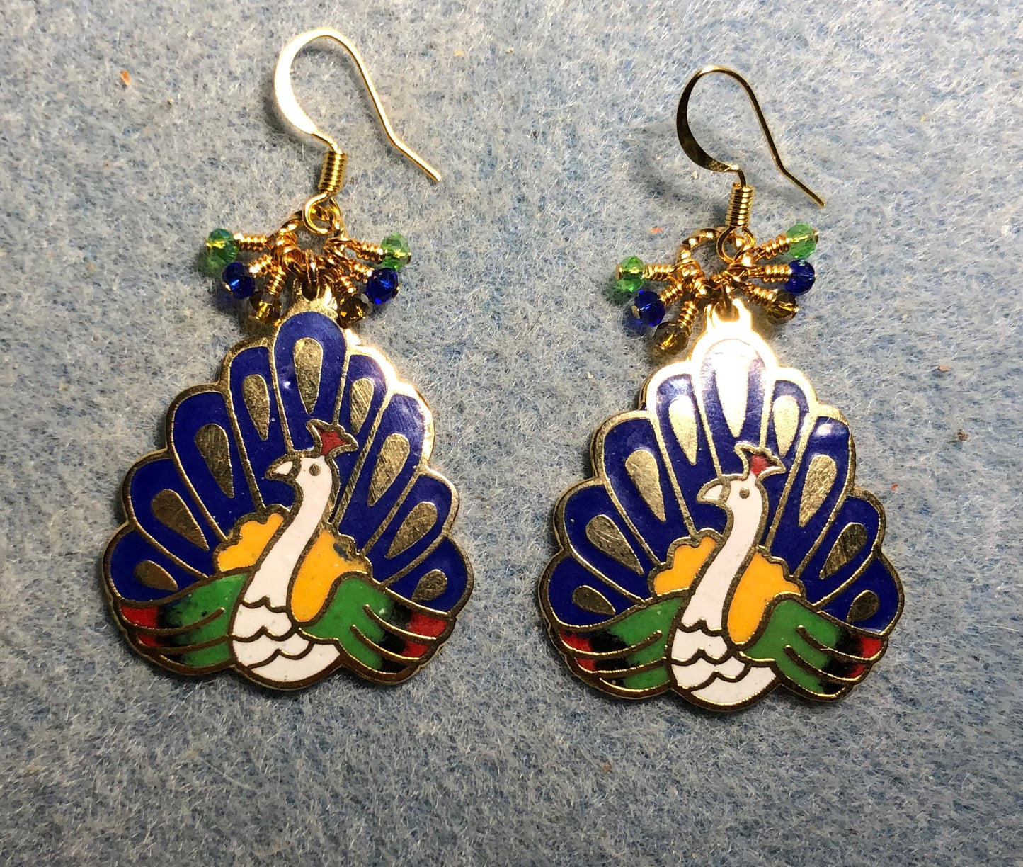 Dark blue, green, and amber cloisonné peacock charm earrings adorned with tiny dark blue, green, and amber Chinese crystal beads.