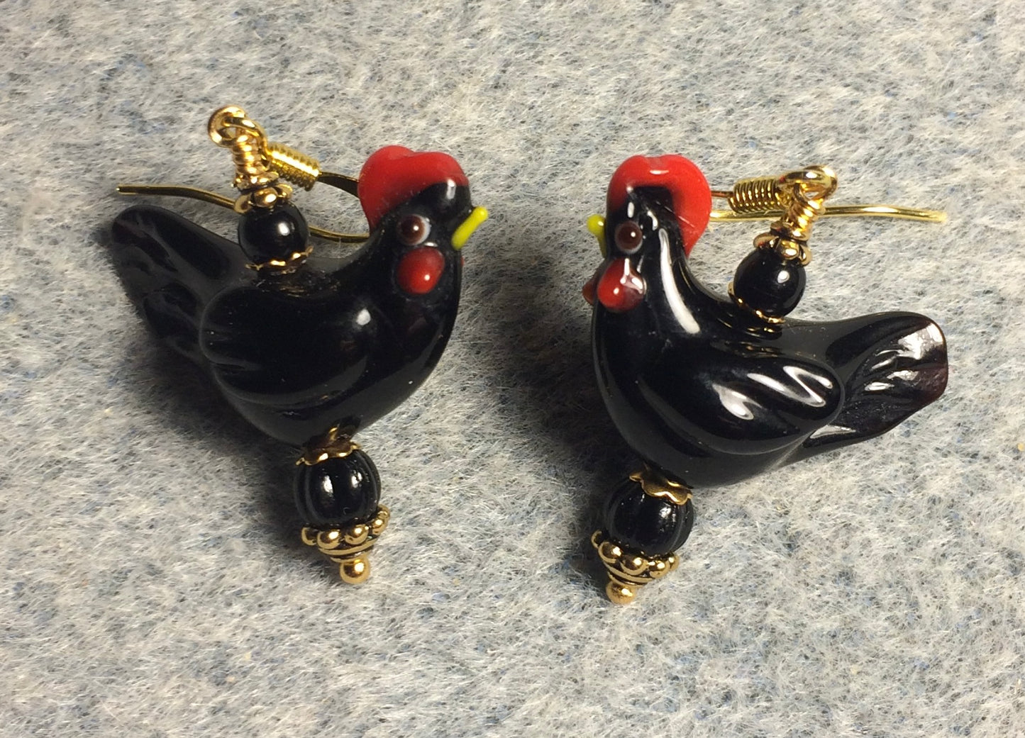Black lamp work chicken bead earrings adorned with black Czech glass beads.