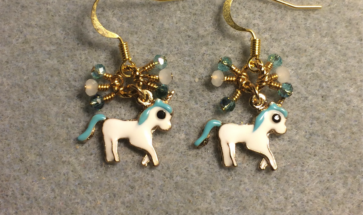 Small white and turquoise enamel unicorn charm earrings adorned with tiny dangling turquoise and white Chinese crystal beads.