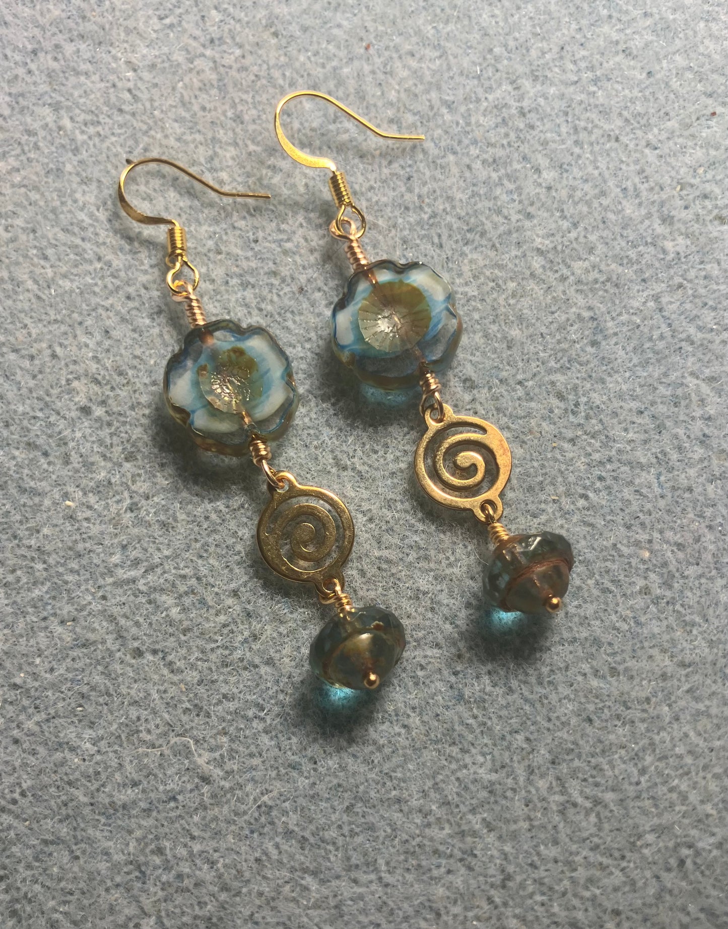 Turquoise and brown Czech glass pansy bead earrings adorned with gold swirly connectors and turquoise and gold Czech glass Saturn beads.