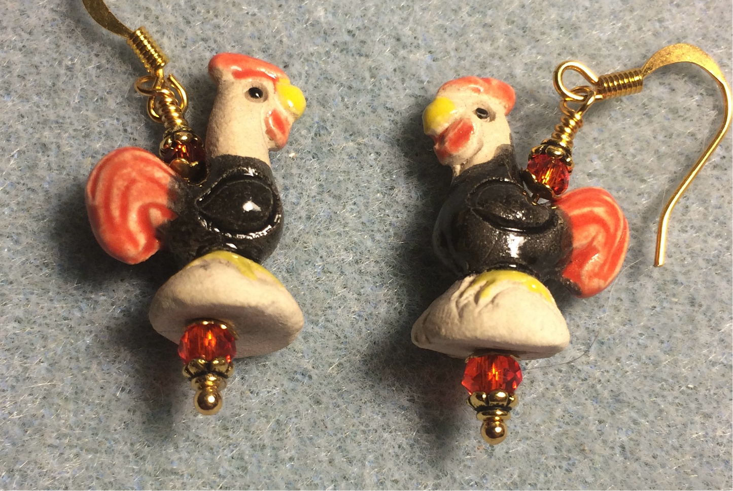Small black, tan, and red ceramic chicken bead earrings adorned with red Chinese crystal beads.