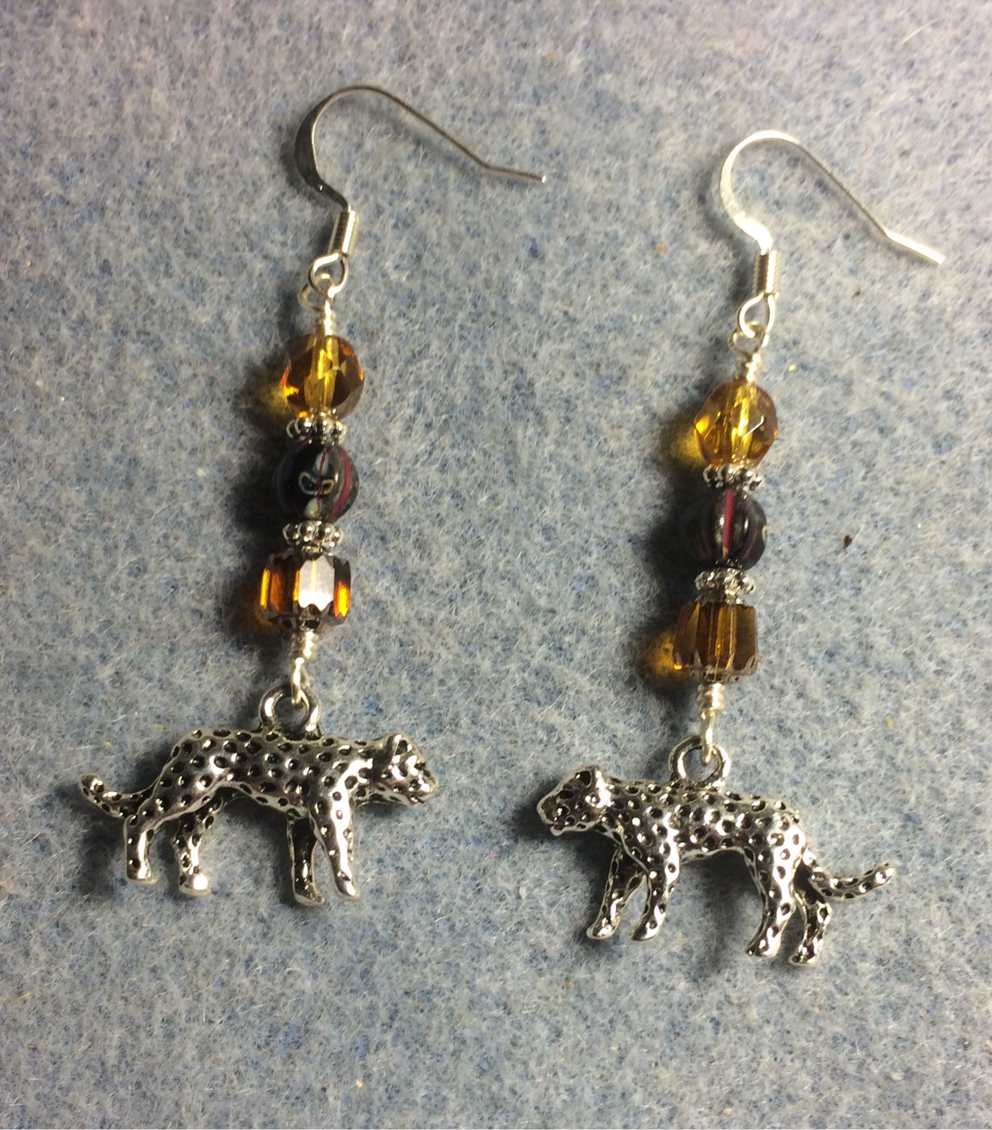 Silver leopard charm earrings adorned with amber and black Czech glass beads