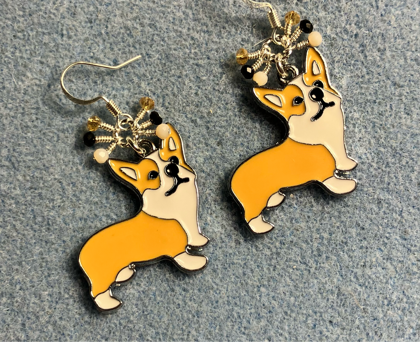 White, black, and tan enamel corgi charm earrings adorned with tiny dangling white, black, and tan Chinese crystal beads.