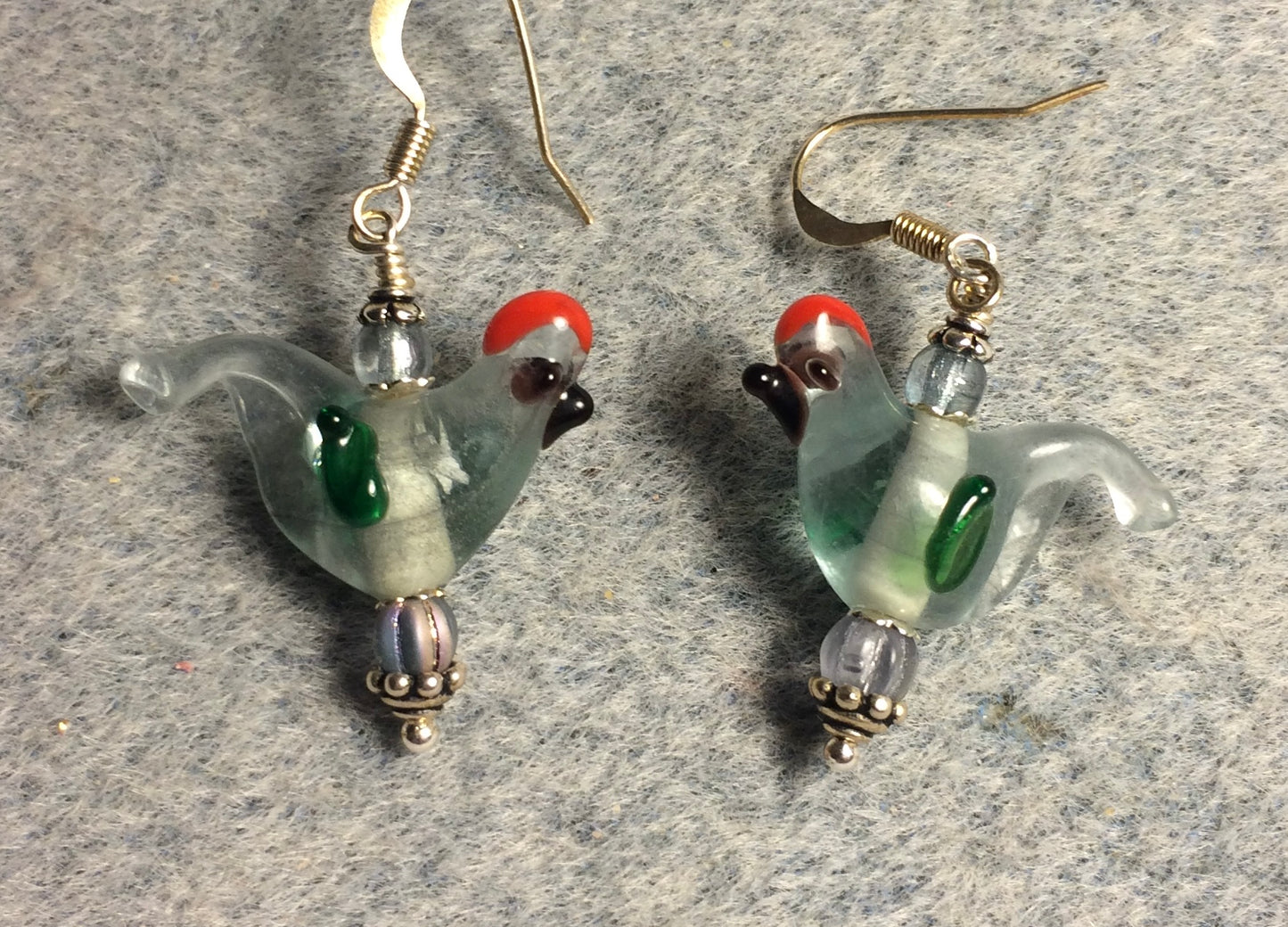 Translucent light blue and green lamp work songbird bead earrings adorned with light blue Czech glass beads.