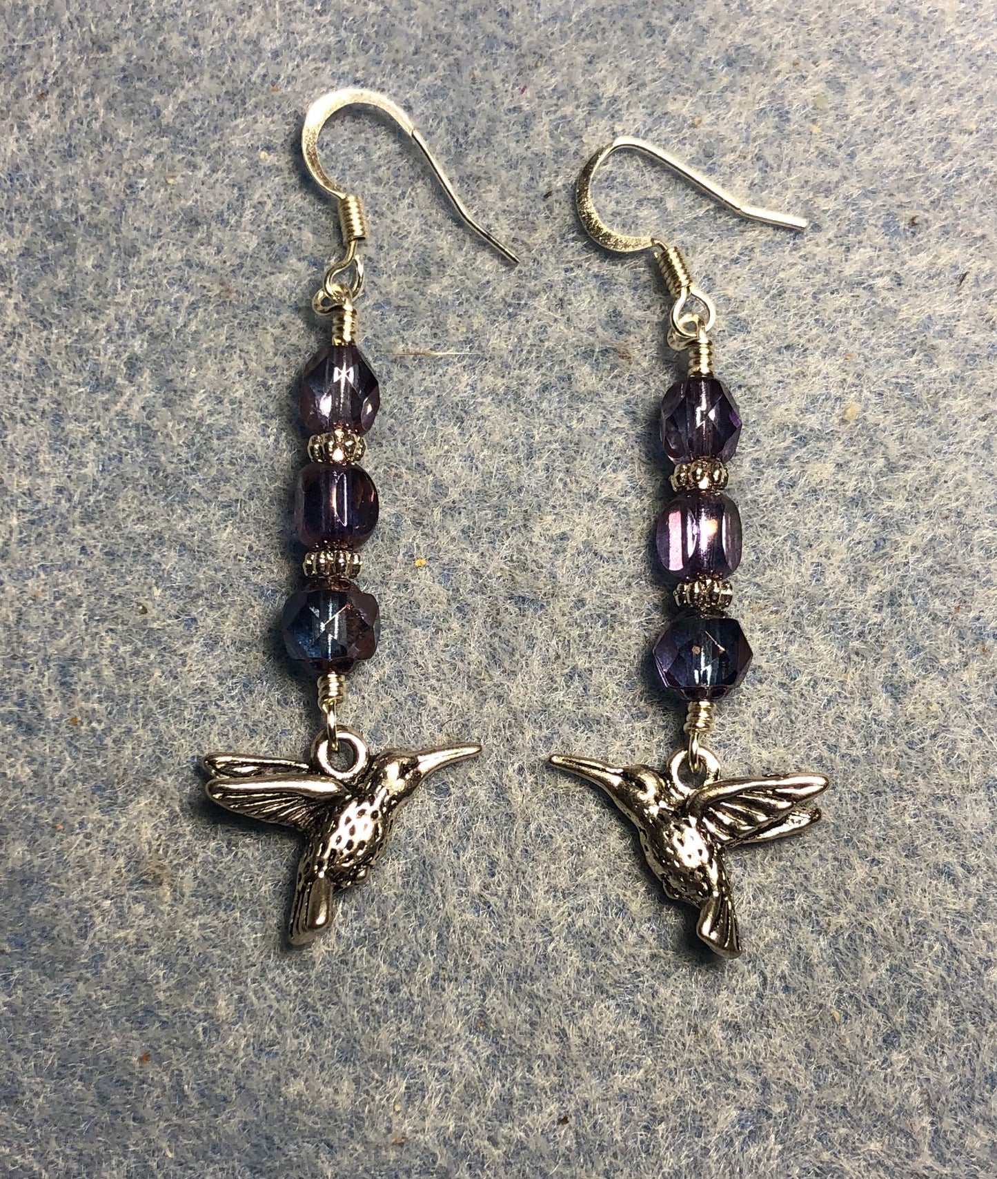 Silver Tierracast hummingbird charm earrings adorned with purple Czech glass beads