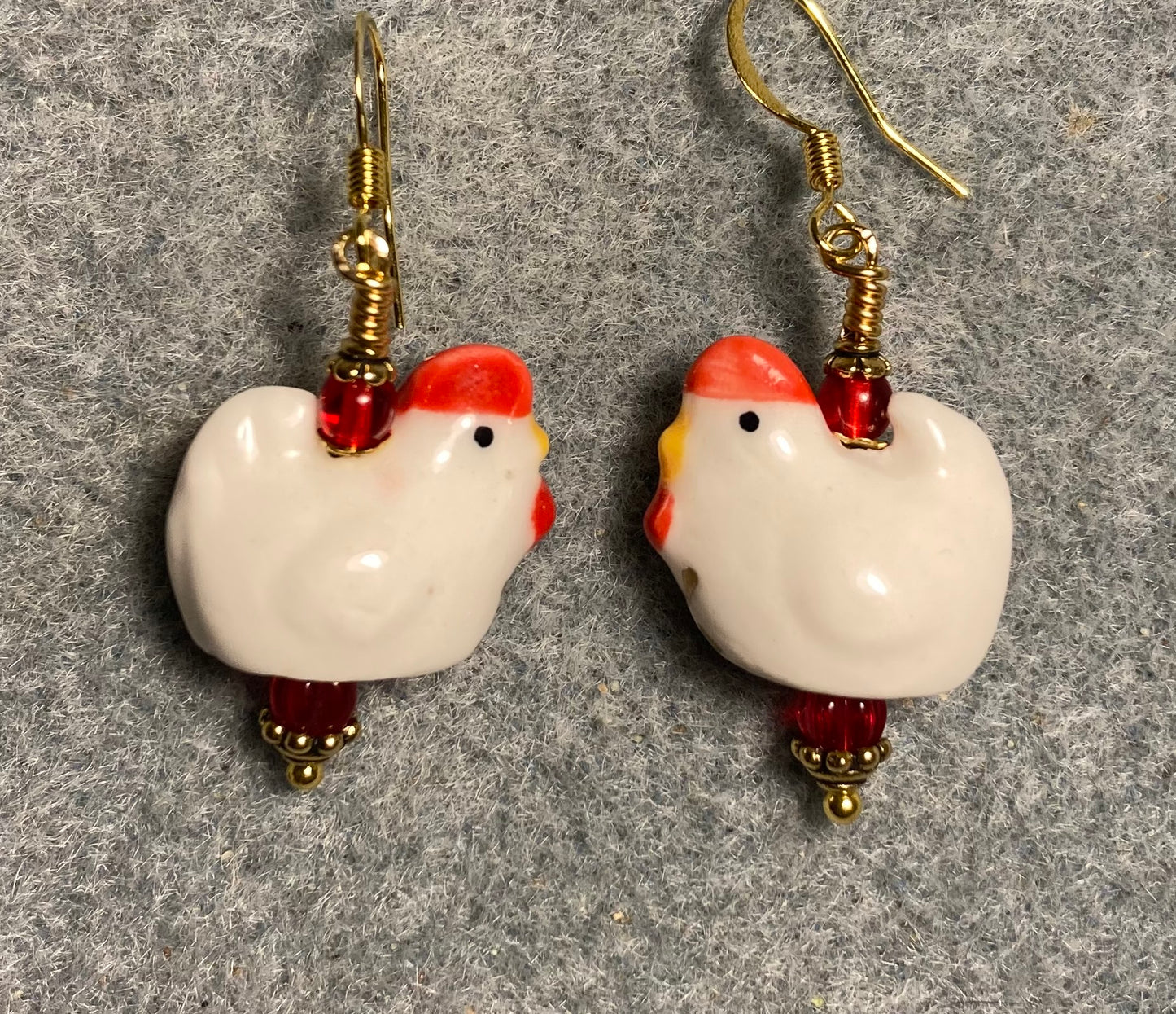 White and red ceramic chicken bead earrings adorned with red Czech glass beads.