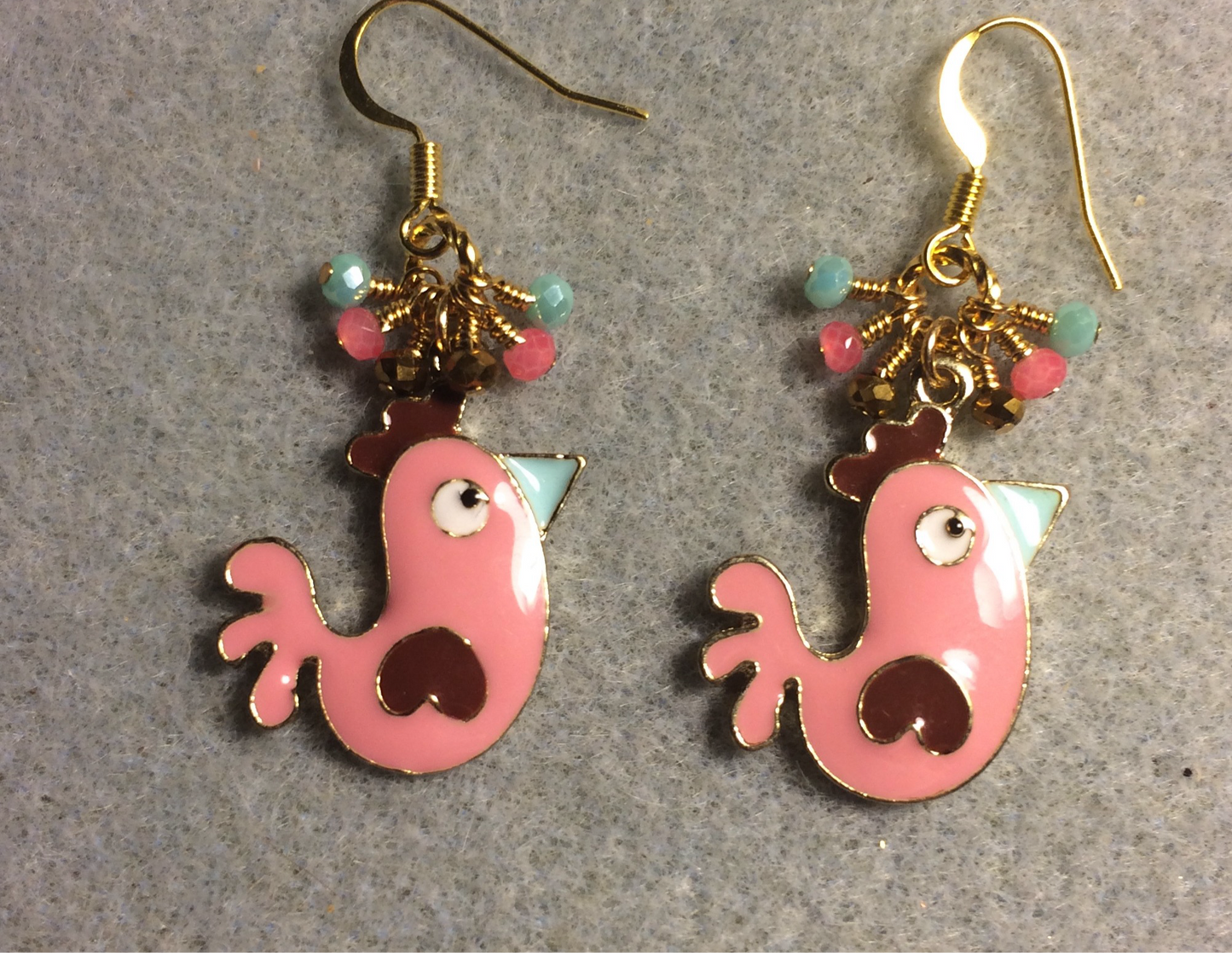 Pink and turquoise enamel chicken charm earrings adorned with tiny dangling pink, turquoise, and gold Chinese crystal beads.
