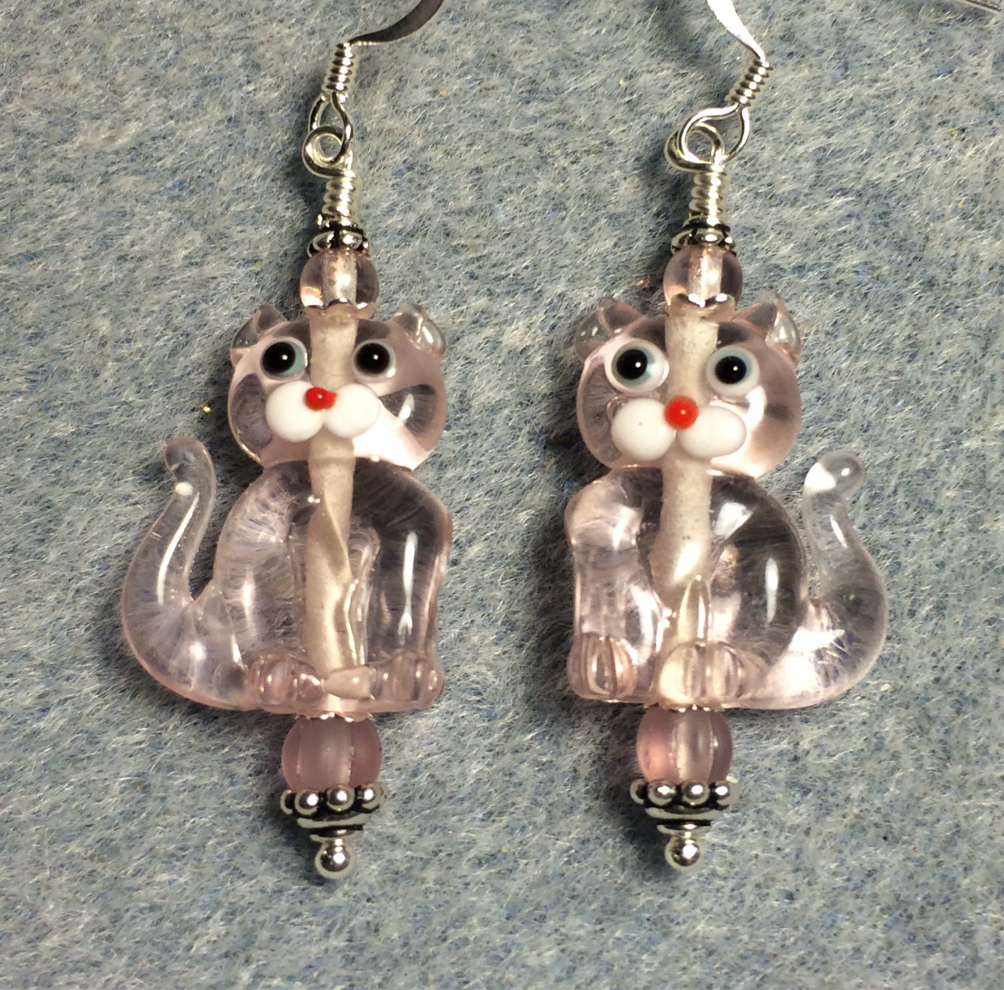 Translucent light pink lamp work cat bead earrings adorned with pink Czech glass beads.