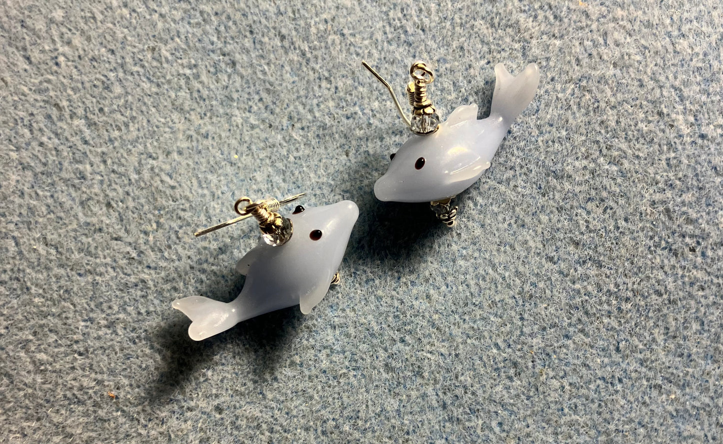 Light blue lamp work whale bead earrings adorned with light blue Chinese crystal beads.