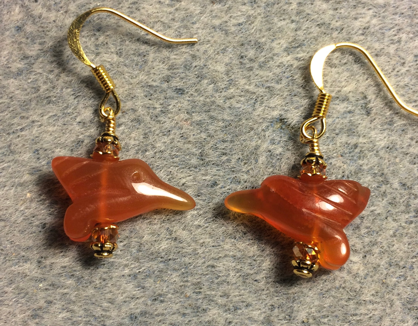 Small carnelian gemstone hummingbird bead earrings adorned with small orange Chinese crystal beads.