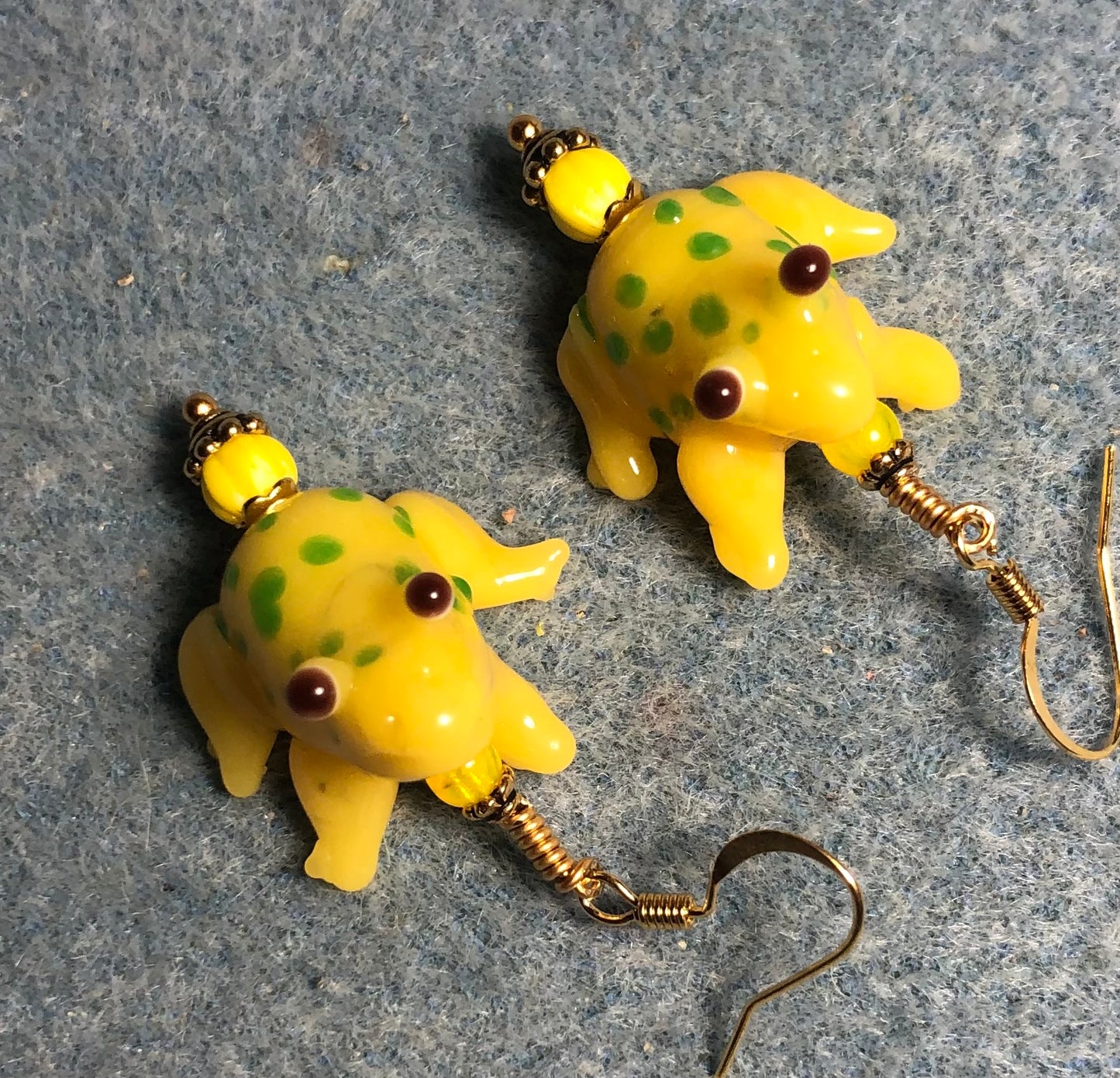 Yellow and green lamp work spotted frog bead earrings adorned with yellow Czech glass beads.
