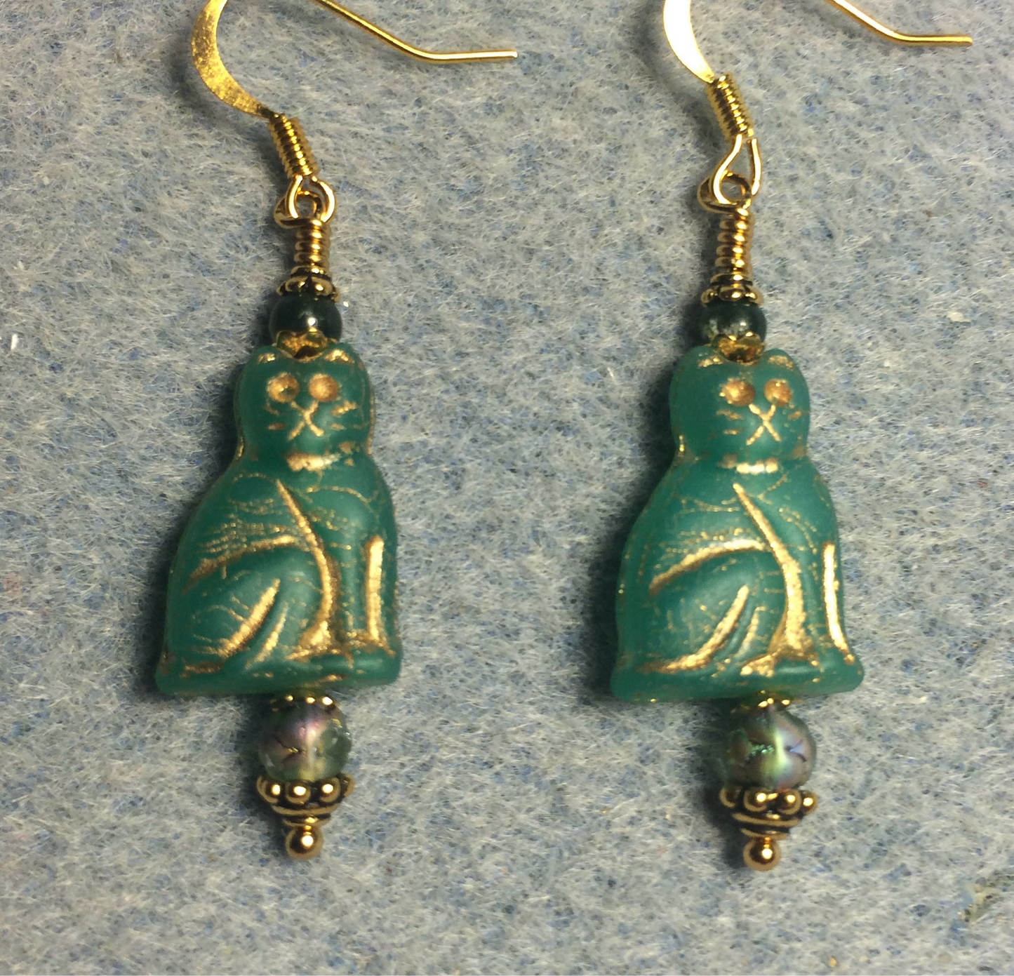 Opaque emerald green (with gold inlay) Czech glass cat bead earrings adorned with emerald green Czech glass beads.