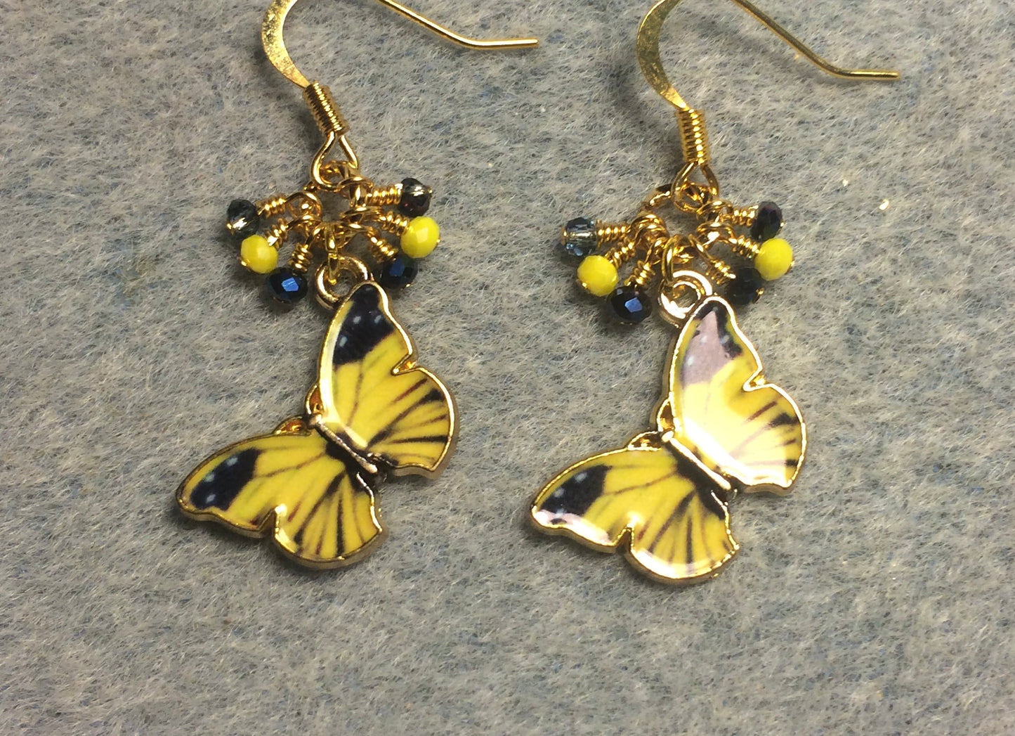 Yellow and blue enamel butterfly charm earrings adorned with tiny dangling yellow and blue Chinese crystal beads.