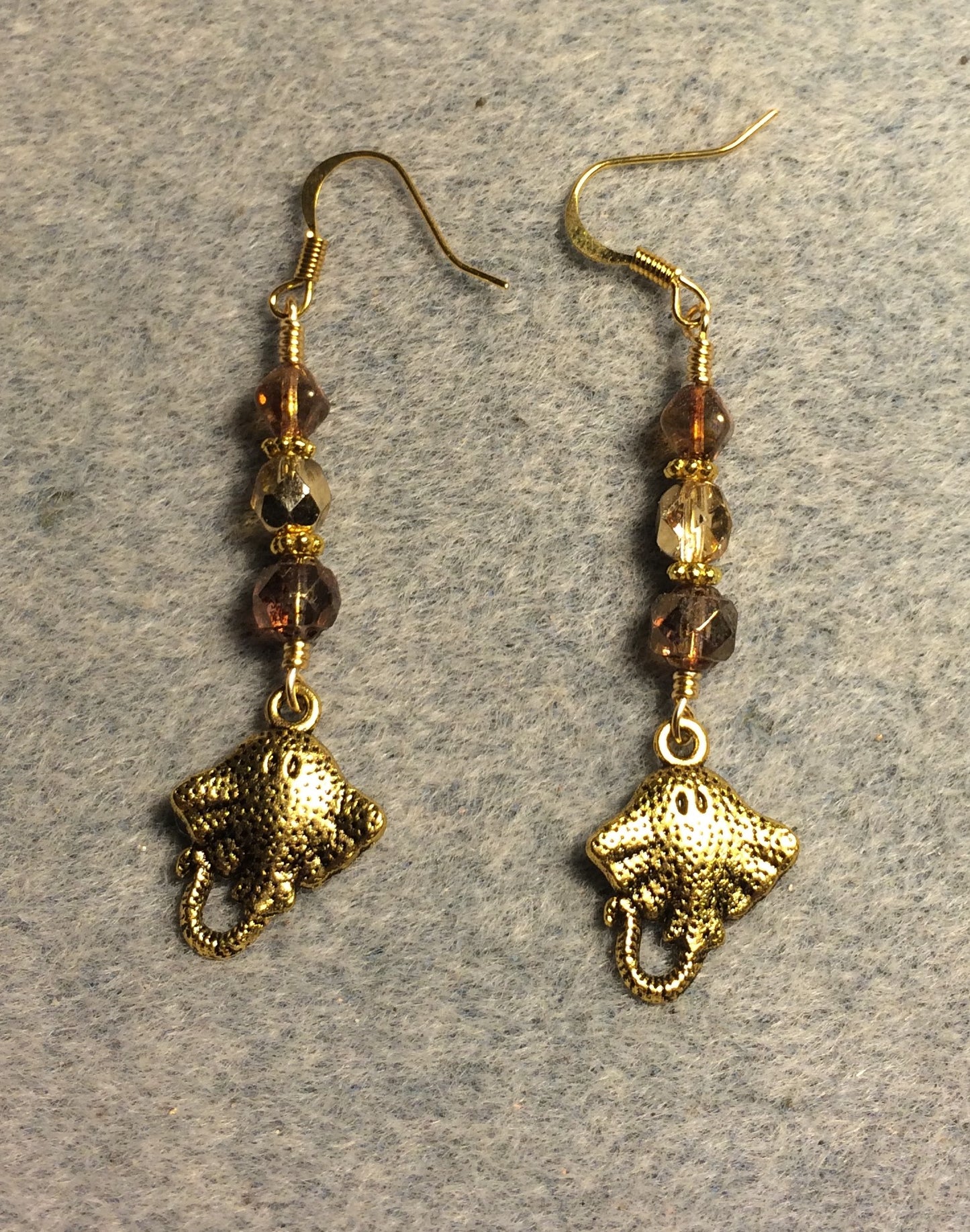 Gold stingray charm earrings adorned with gold Czech glass beads