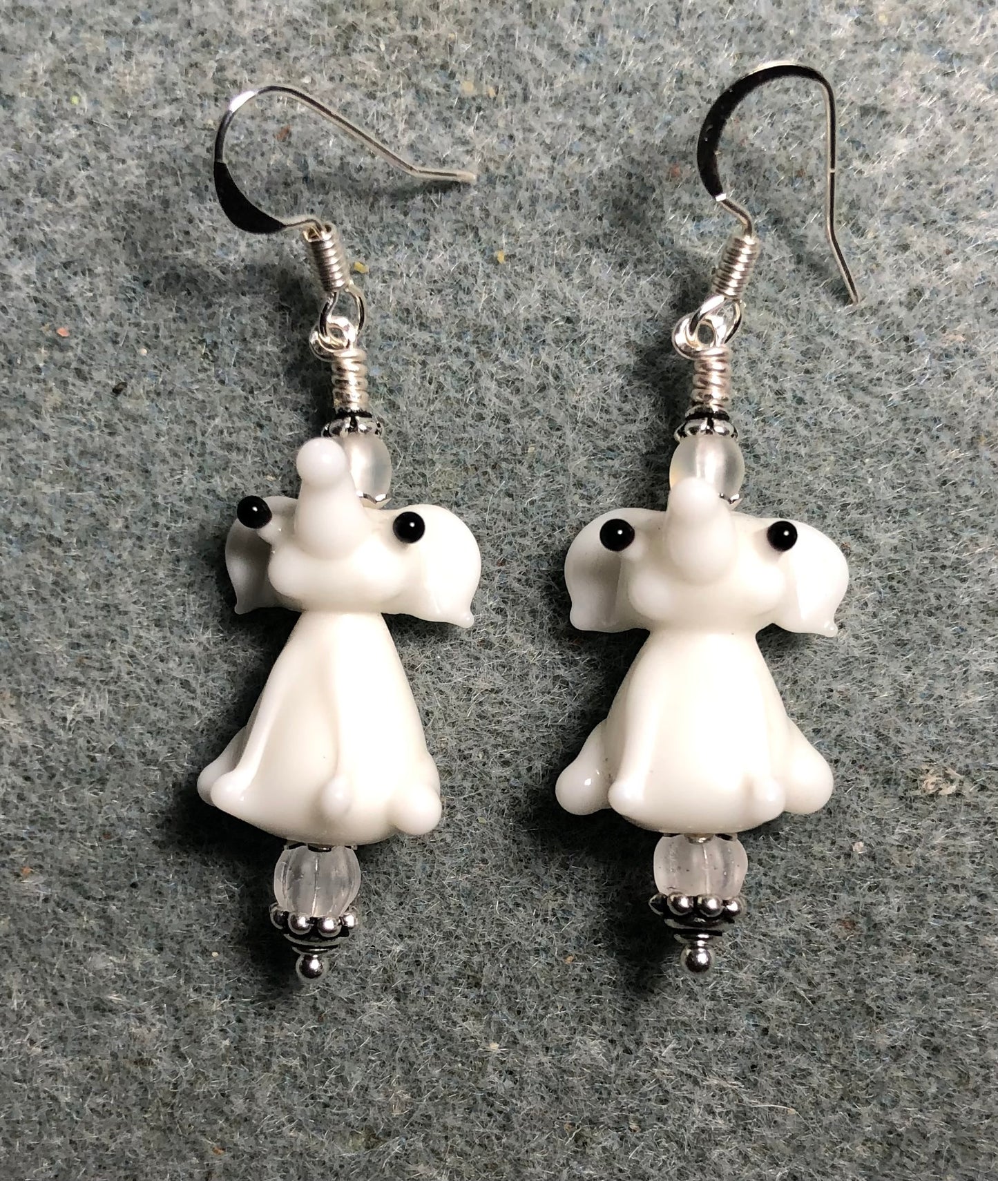 Opaque white lamp work sitting elephant bead earrings adorned with frosty white Czech glass beads.