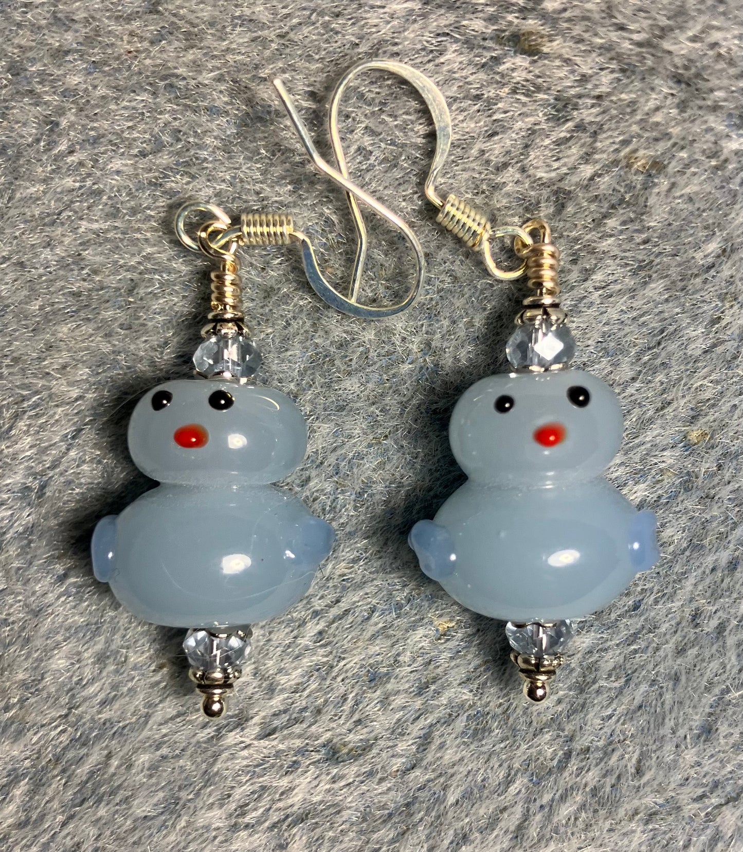 Opaque light blue lamp work duck bead earrings adorned with light blue Chinese crystal beads.