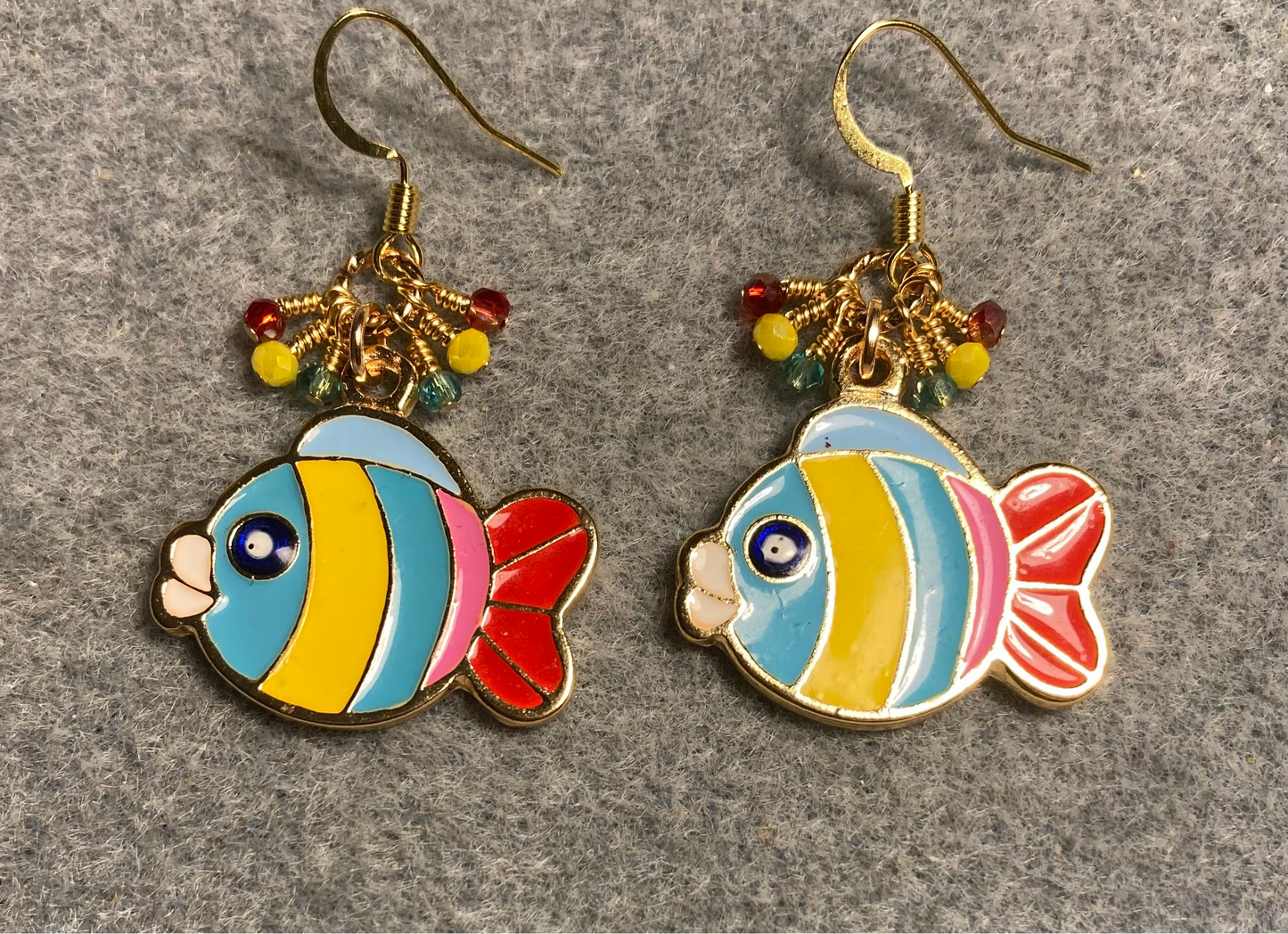 Turquoise, red, and yellow enamel striped fish charm earrings adorned with tiny dangling turquoise, red, and yellow Chinese crystal beads.