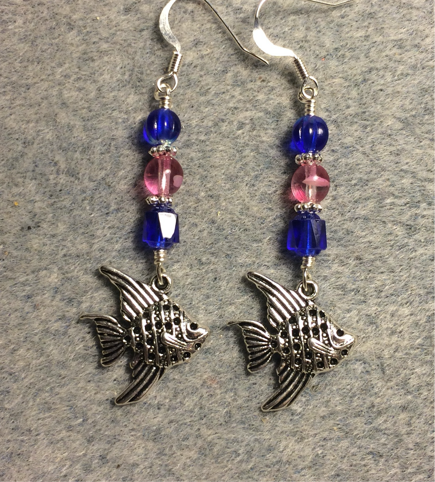 Silver angelfish charm earrings adorned with dark blue and bright pink Czech glass beads