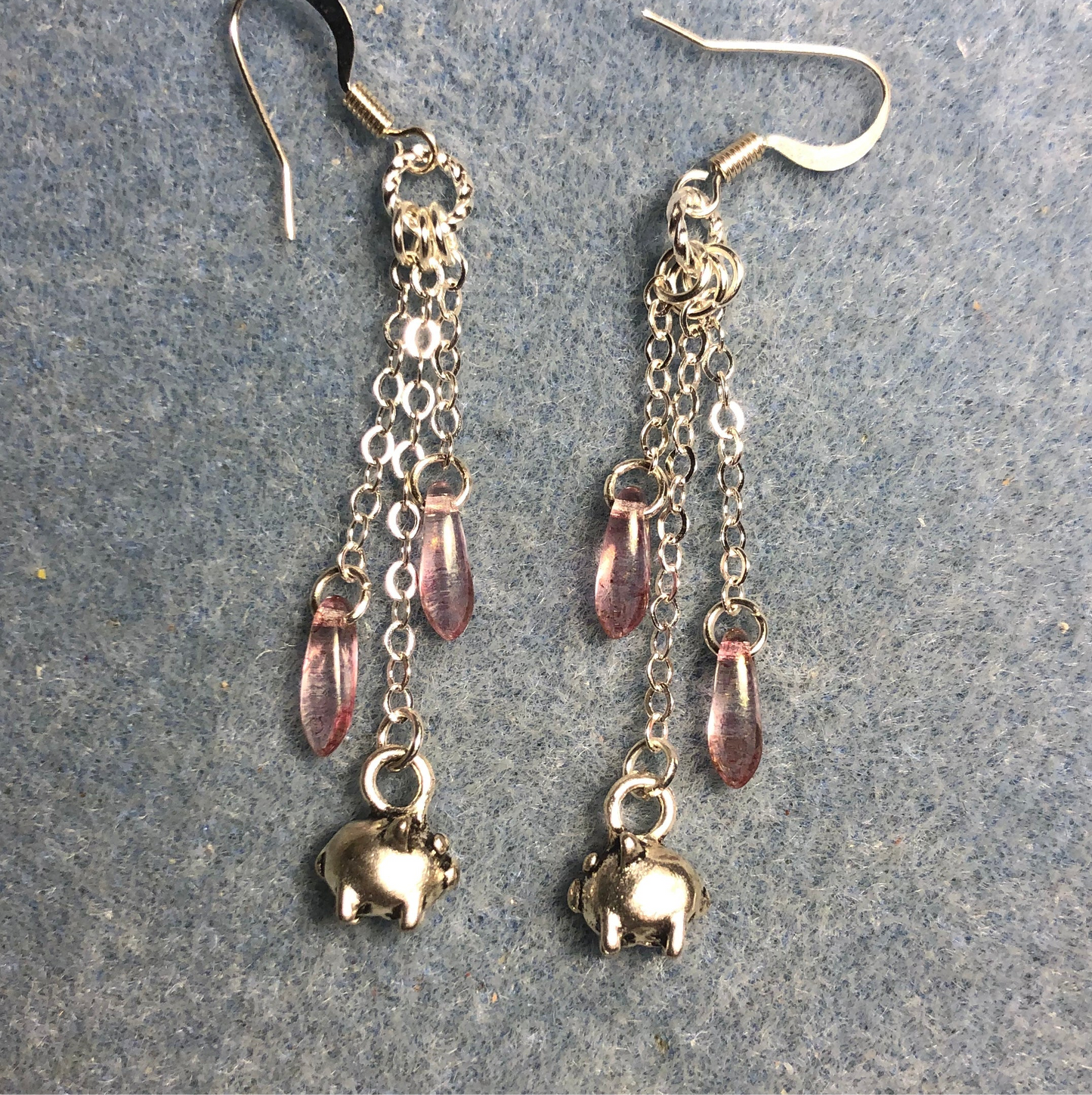 Small silver pig charm earrings attached to silver chain and at adorned with small pink Czech glass dagger beads