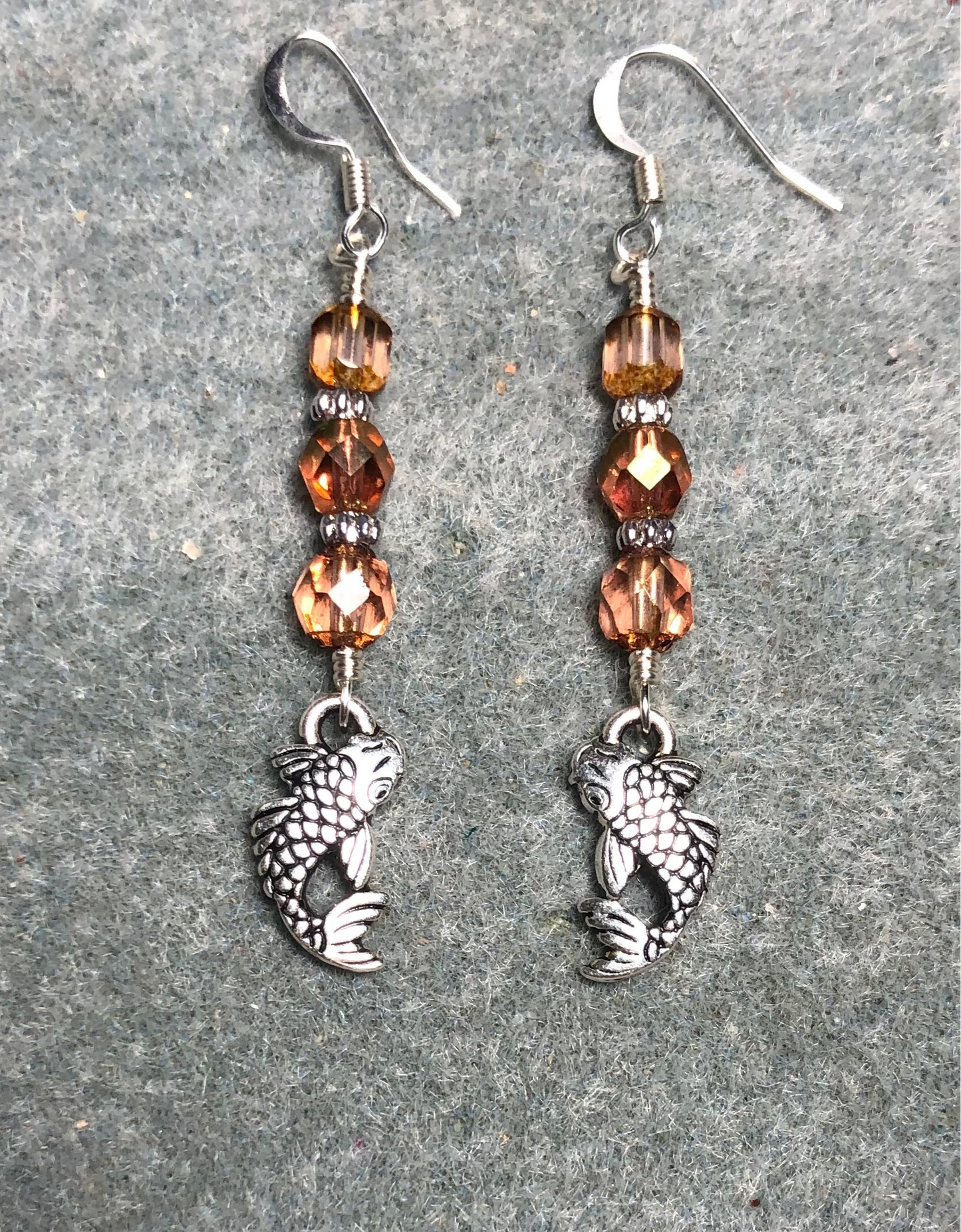 Silver koi charm earrings adorned with rose gold Czech glass beads.