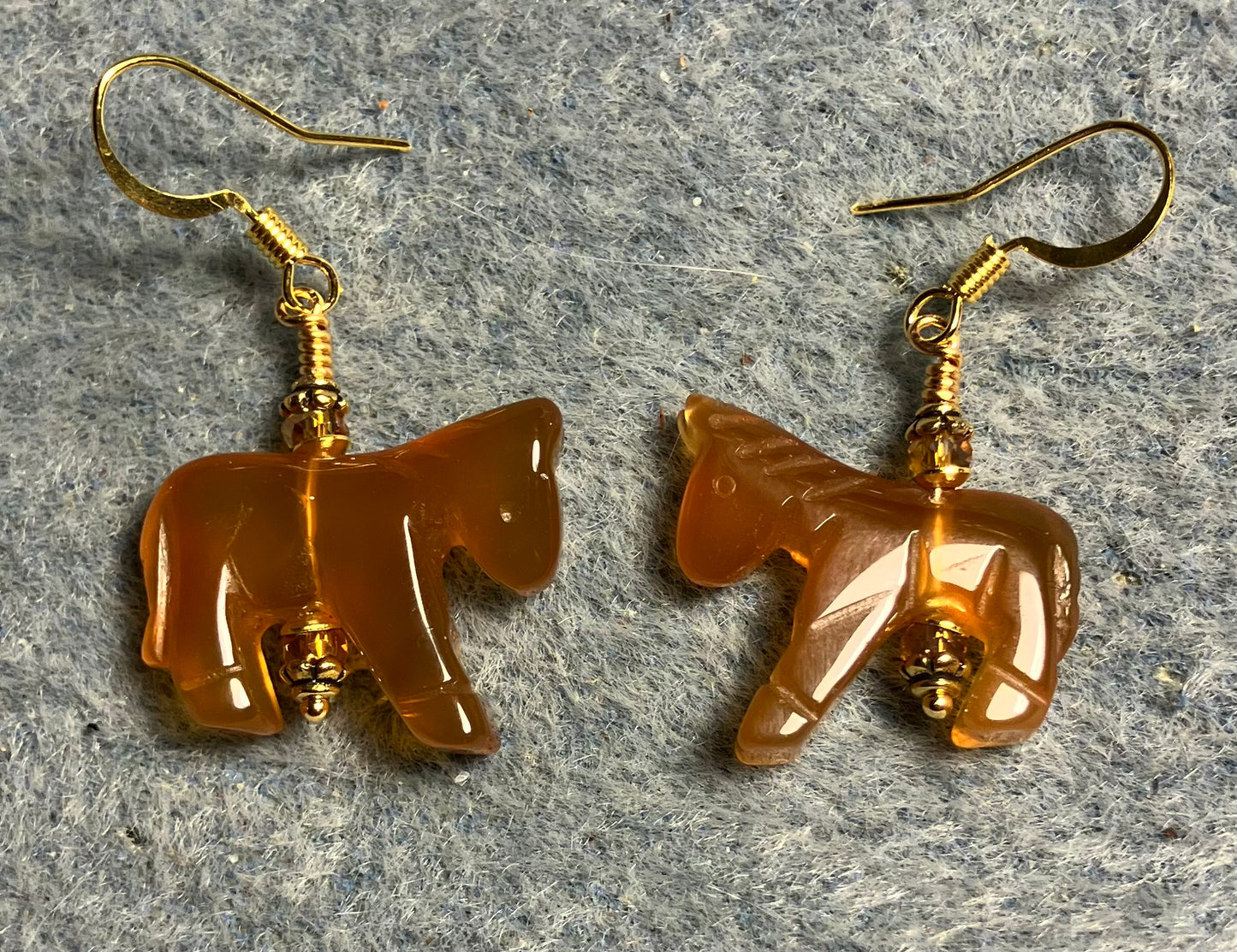 Orange carnelian gemstone horse bead earrings adorned with orange Chinese crystal beads.