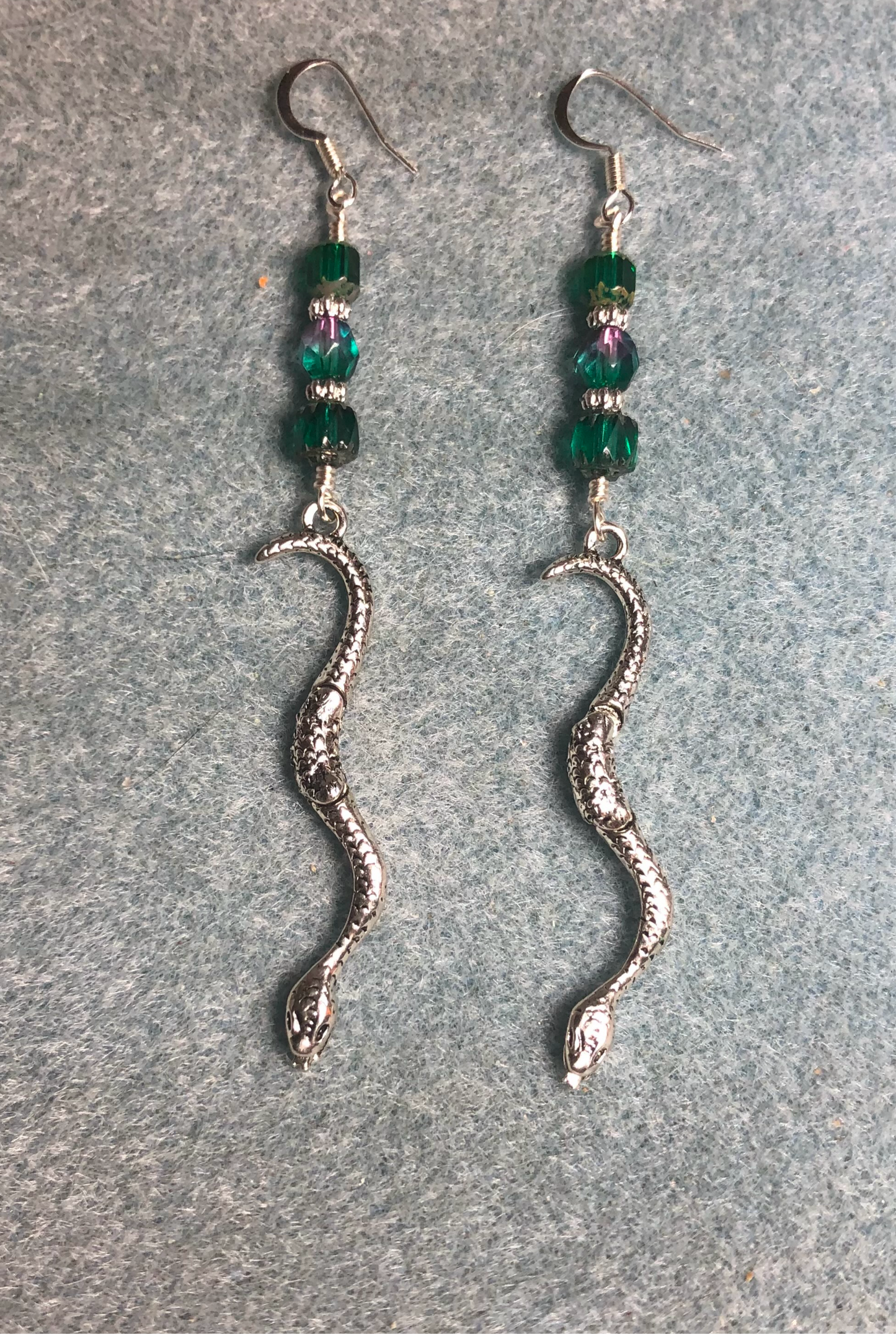 Long silver snake charm earrings adorned with teal and teal purple Czech glass beads