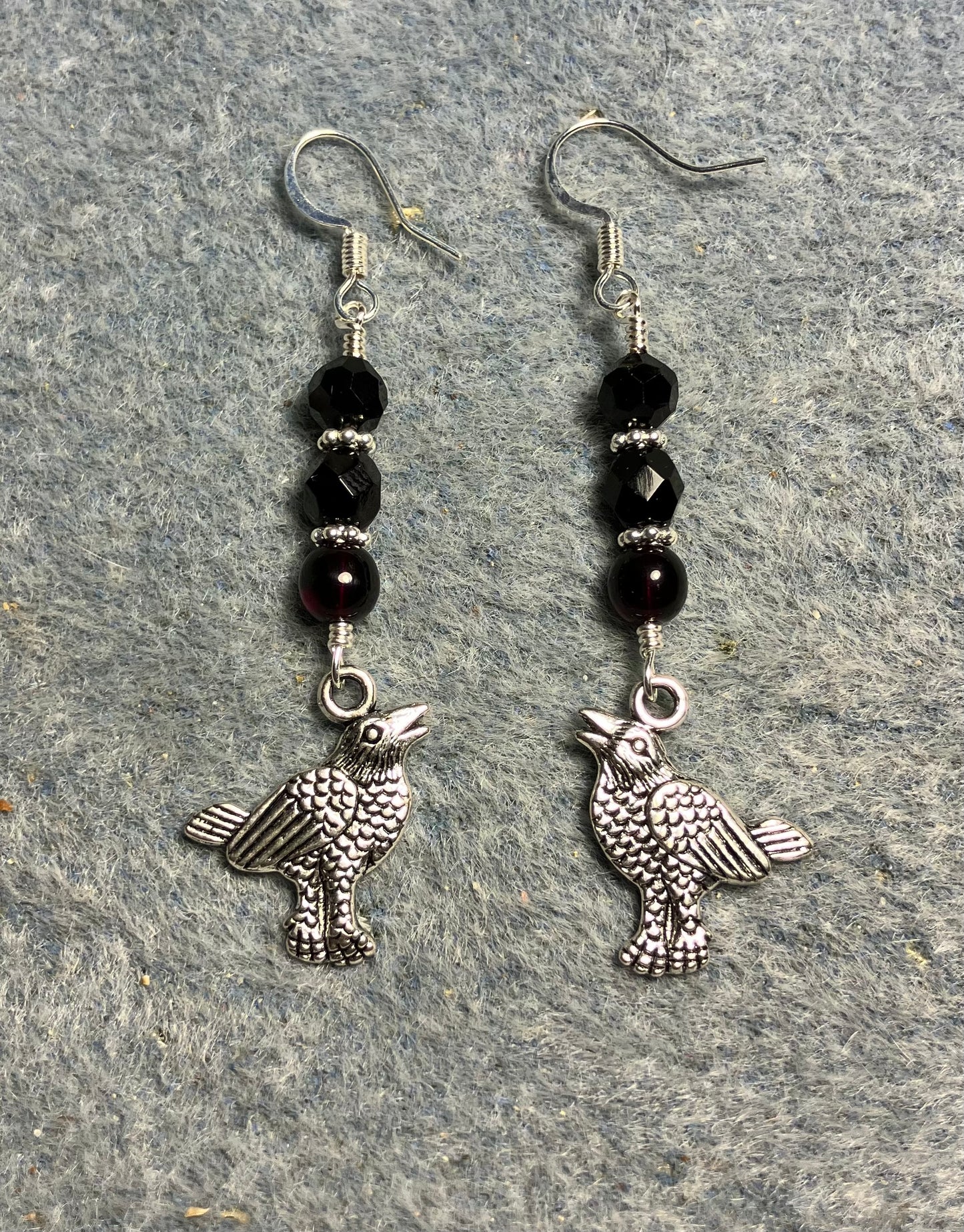 Silver raven charm earrings adorned with black Czech glass beads