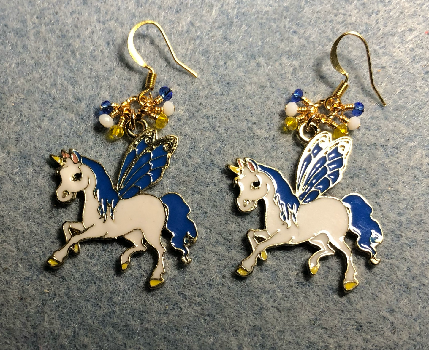 Large blue, white, and yellow enamel Pegasus charm earrings adorned with tiny dangling blue, white, and yellow Chinese crystal beads.