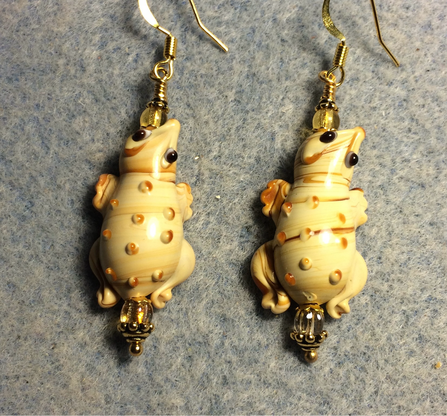 Tan lamp work lizard bead earrings adorned with amber Czech glass beads.