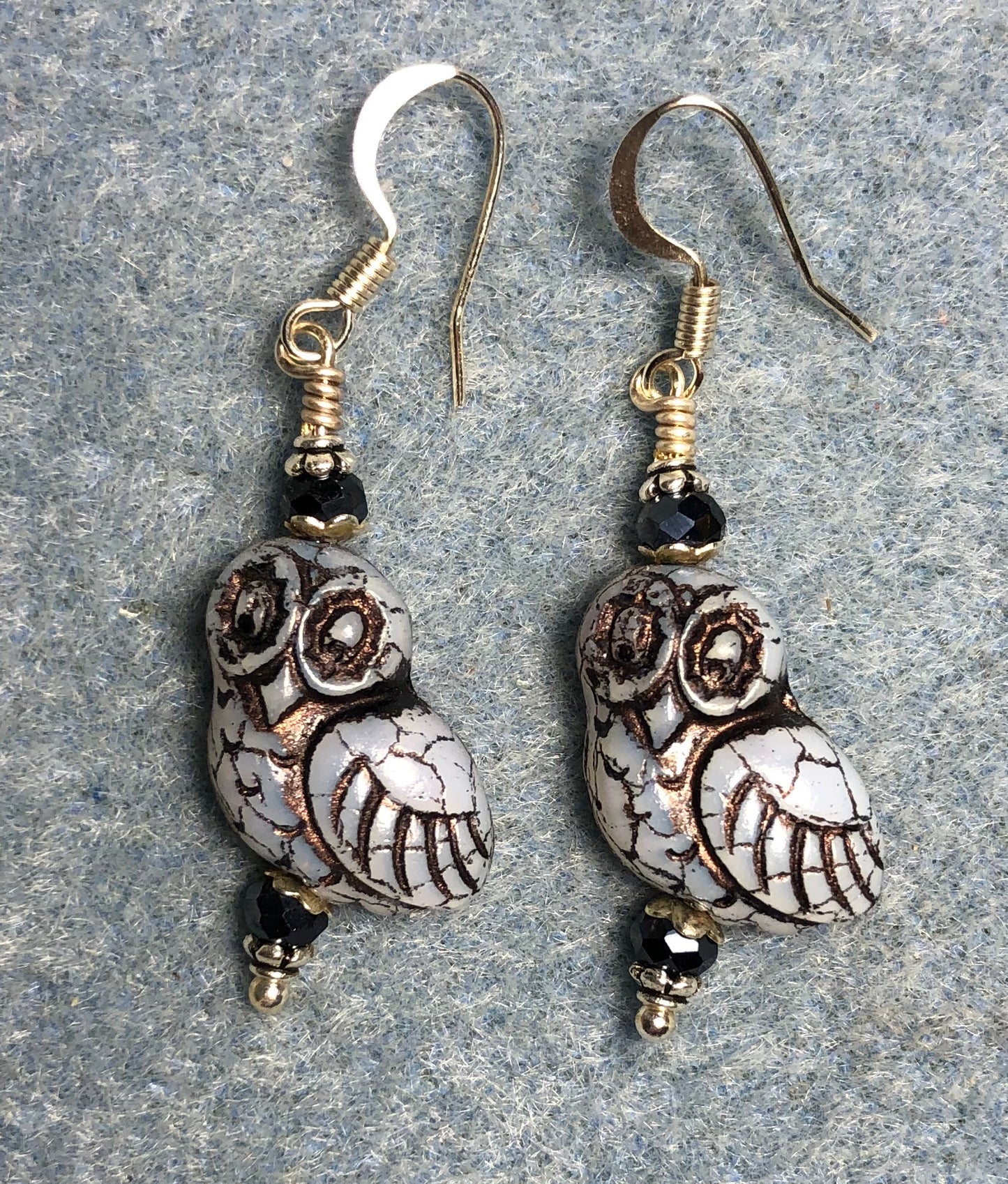 Light blue (with black wash) fancy Czech glass owl bead earrings adorned with black Chinese crystal beads.