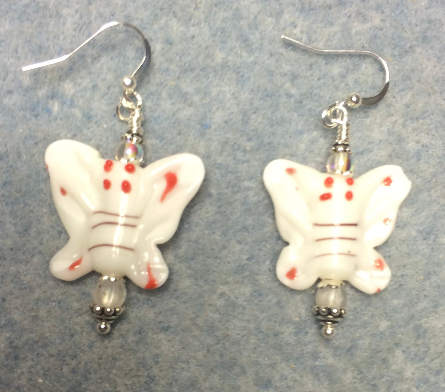 White lamp work butterfly bead earrings adorned with clear Czech glass beads.