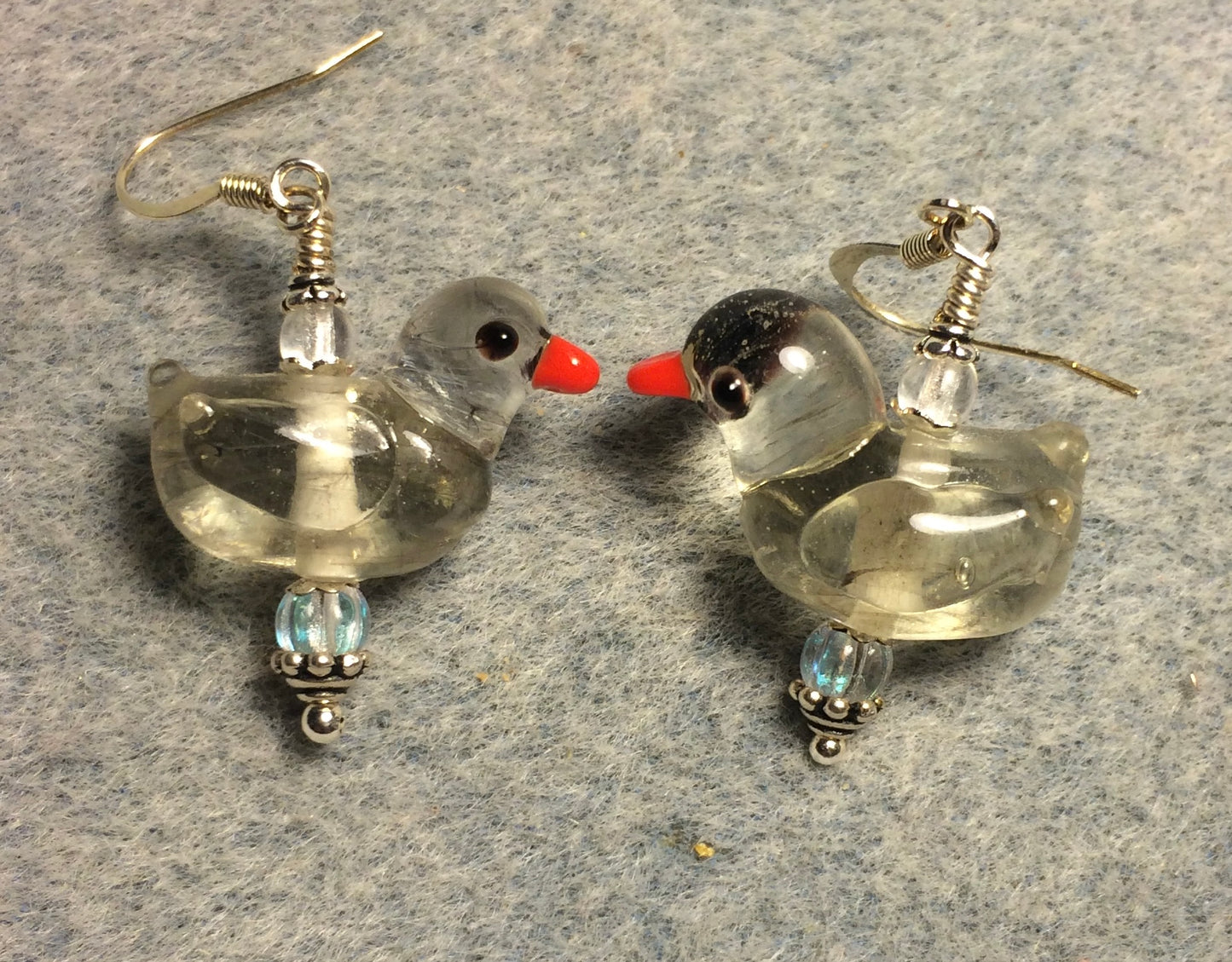 Translucent clear lamp work duck bead earrings adorned with clear Czech glass beads.