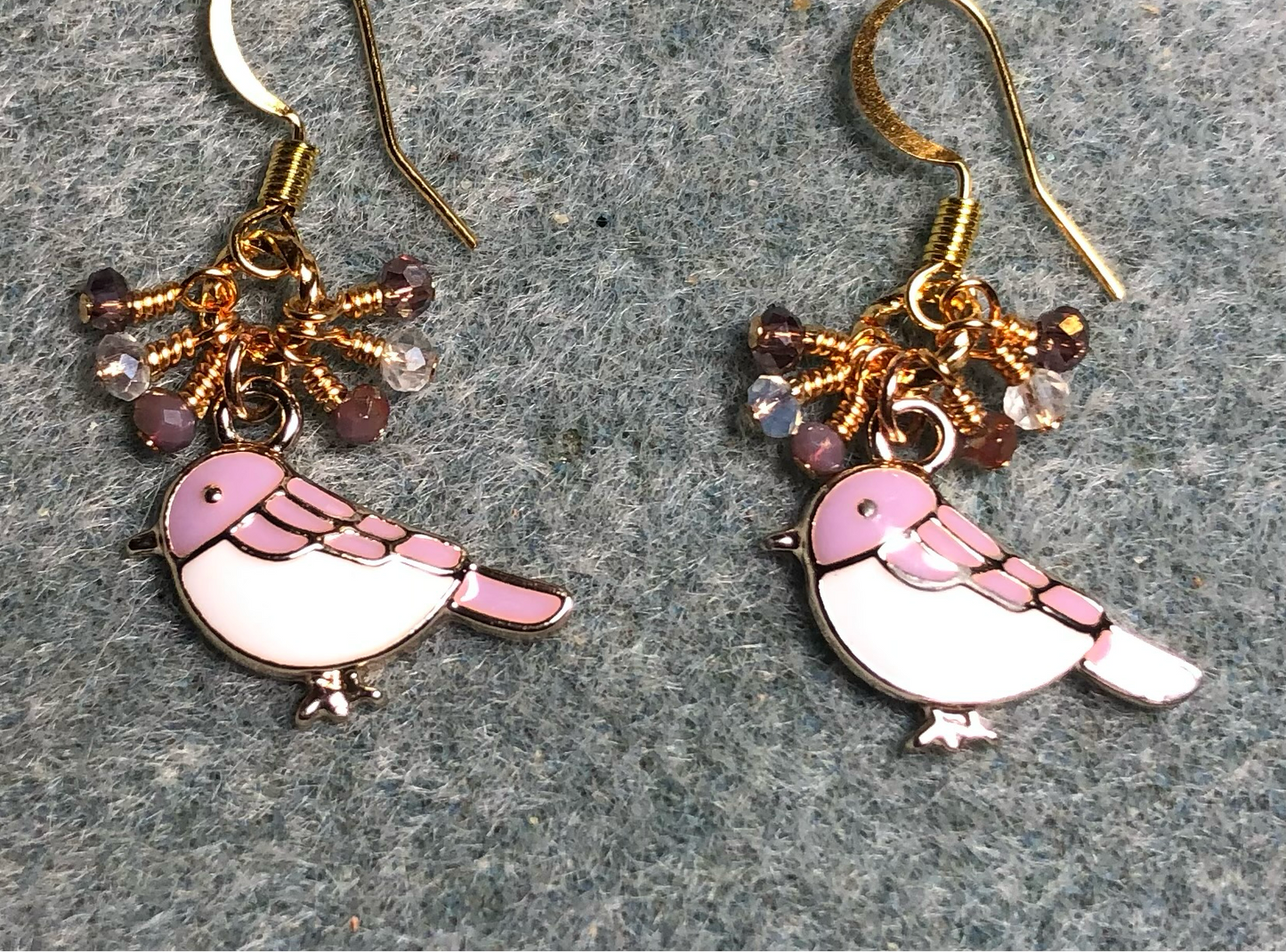 Small violet and white enamel songbird charm earrings adorned with tiny dangling violet and clear Chinese crystal beads.