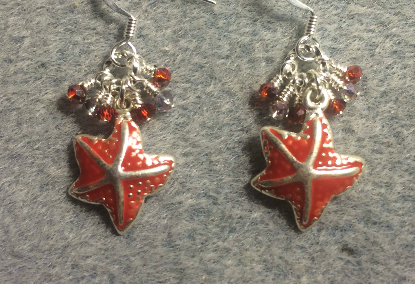 Red enamel starfish charm earrings adorned with tiny dangling red and clear Chinese crystal beads.