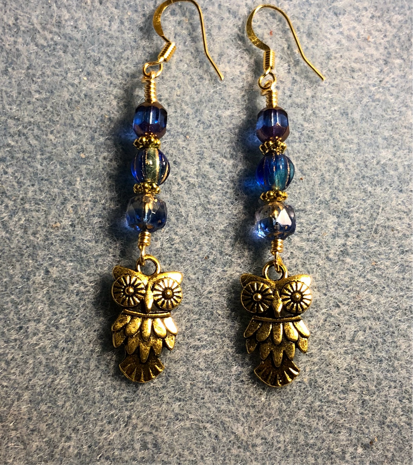 Gold owl charm earrings adorned with blue Czech glass beads