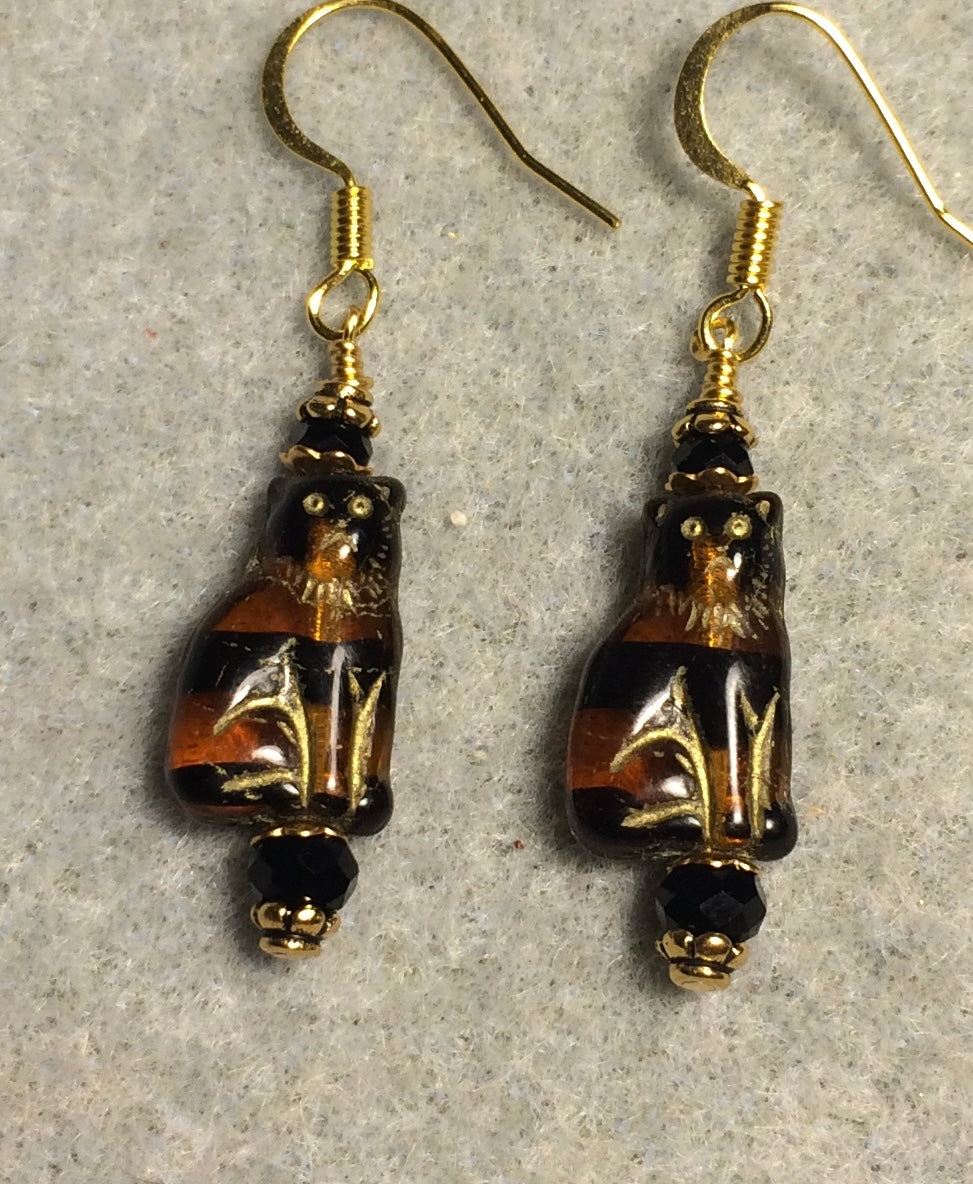 Small brown and black (with gold inlay) Czech glass cat bead earrings adorned with black Chinese crystal beads.