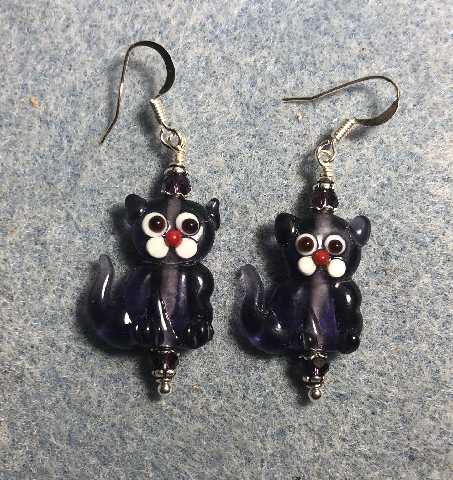 Translucent grape purple lamp work cat bead earrings adorned with purple Chinese crystal beads.