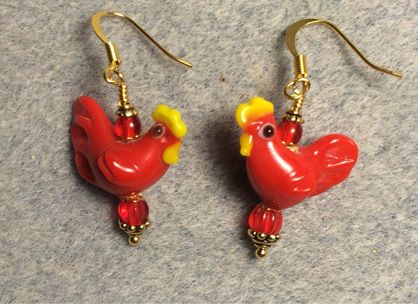 Bright red lamp work chicken bead earrings adorned with red Czech glass beads.