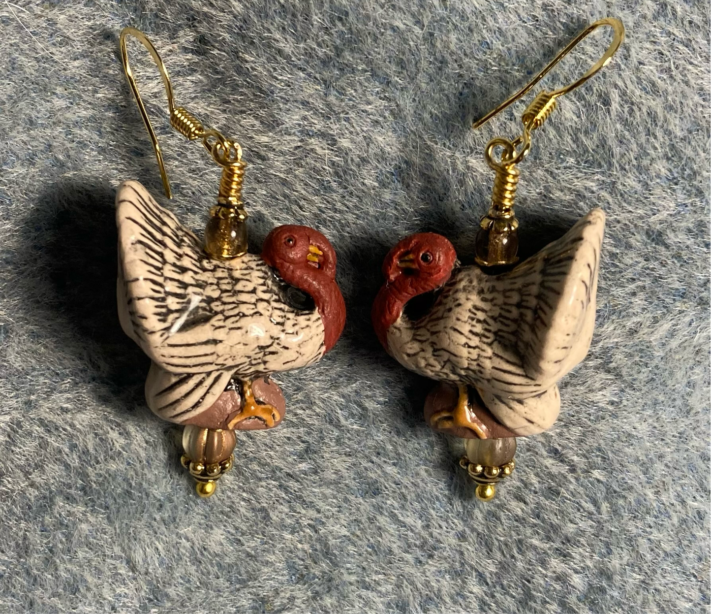 Tan and red ceramic turkey bead earrings adorned with tan Czech glass beads.