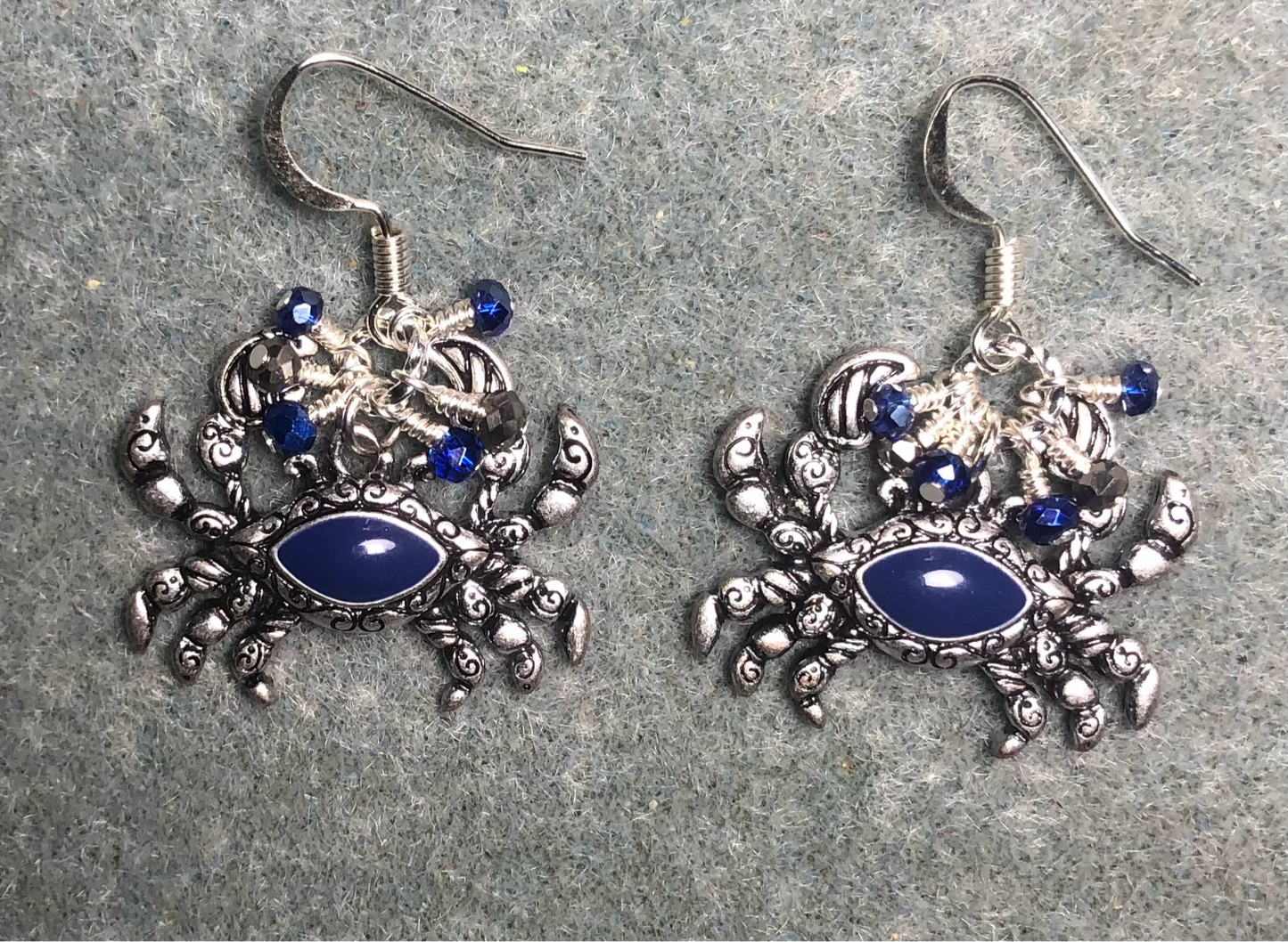 Silver and blue stone crab charm earrings adorned with tiny dangling silver and dark blue Chinese crystal beads.
