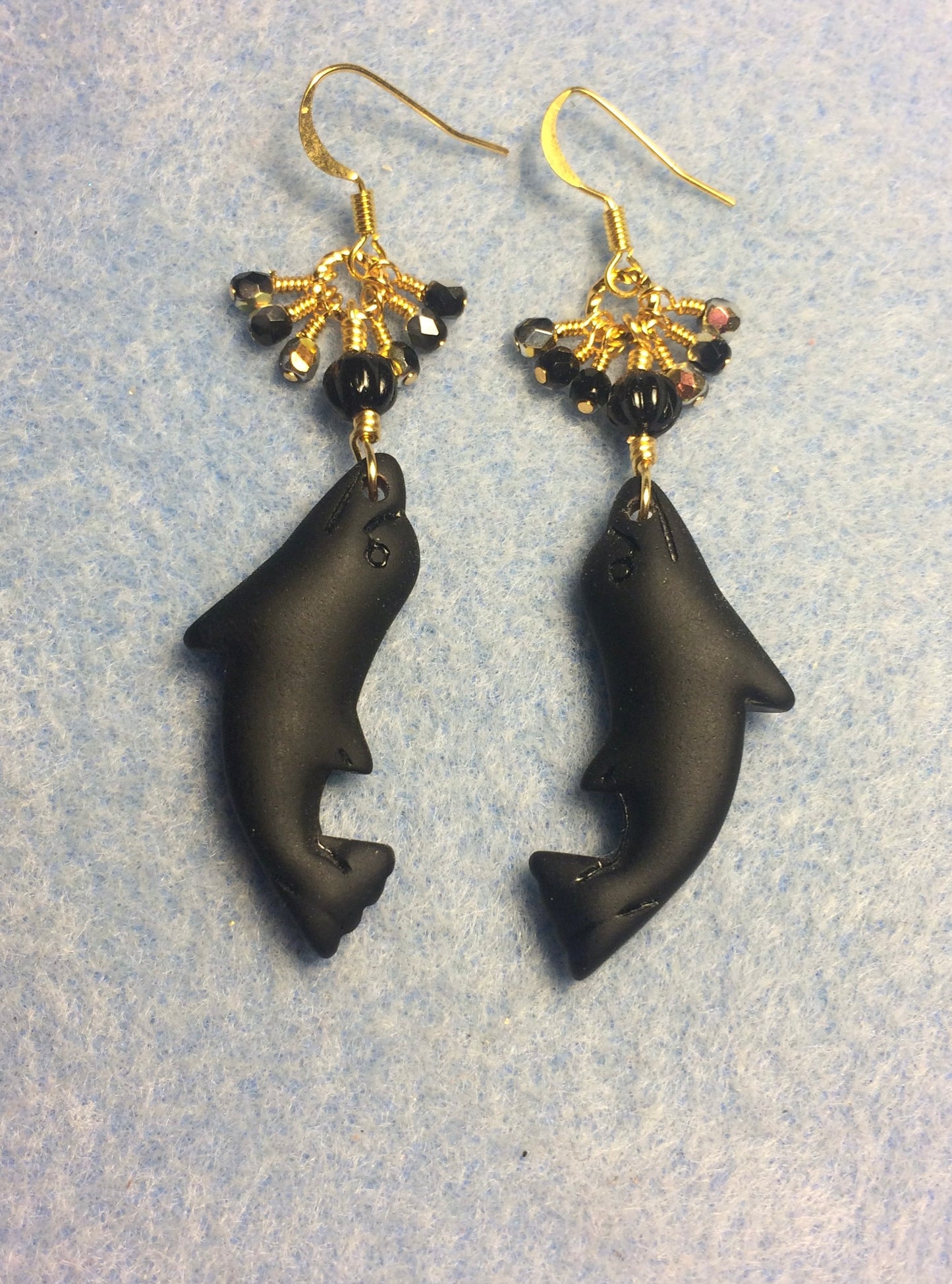 Black sea glass dolphin pendant bead earrings adorned with black Czech glass beads and tiny dangling black Czech glass beads.