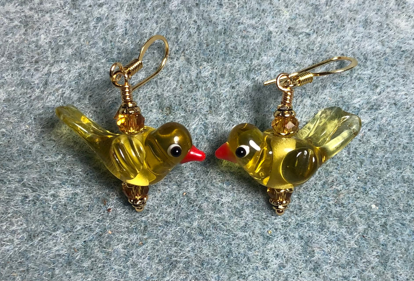 Translucent amber lamp work songbird bead earrings adorned with amber Chinese crystal beads.