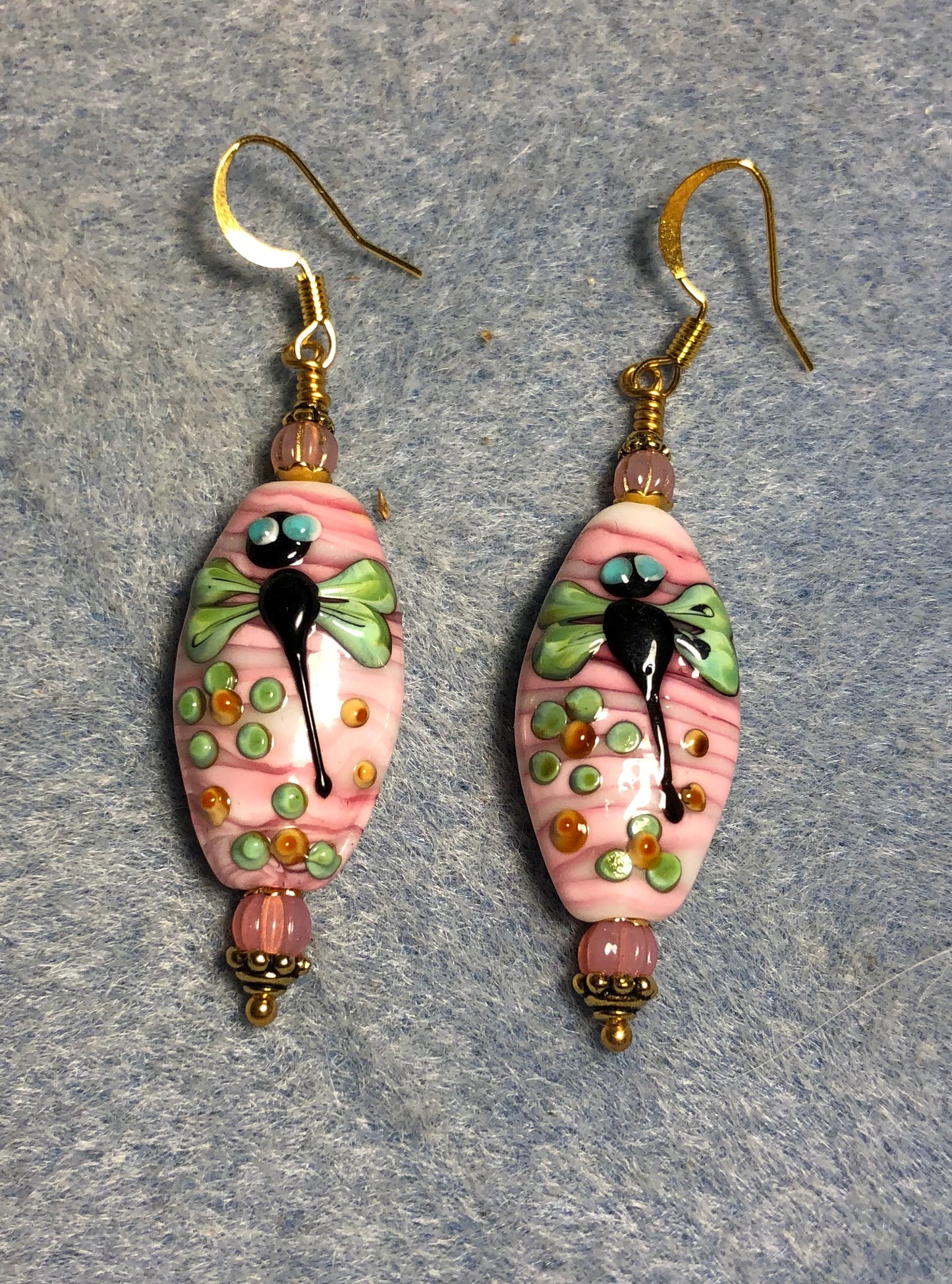 Pink and green lamp work dragonfly bead earrings adorned with pink Czech glass beads.