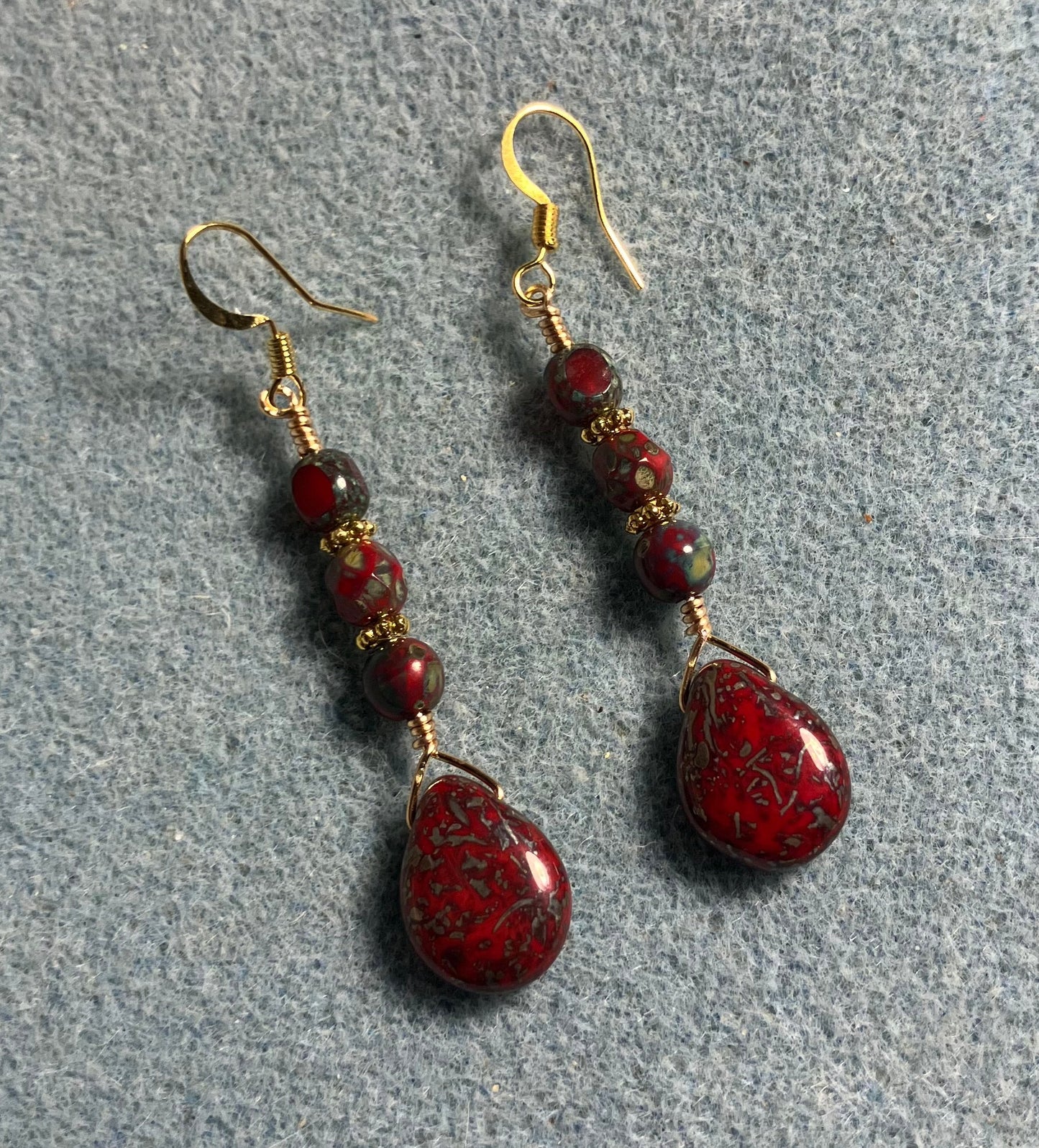 Dark red Picasso Czech glass pear drop bead earrings adorned with dark red Picasso Czech glass beads.