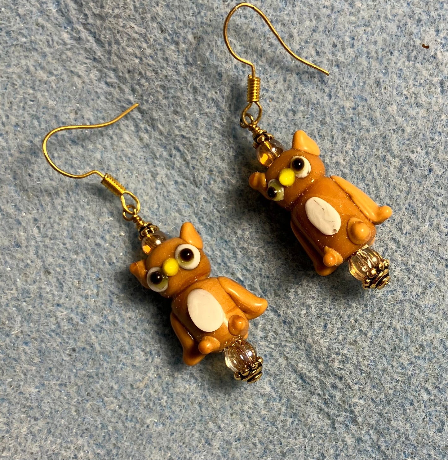 Tan and white lamp work owl bead earrings adorned with tan Czech glass beads.