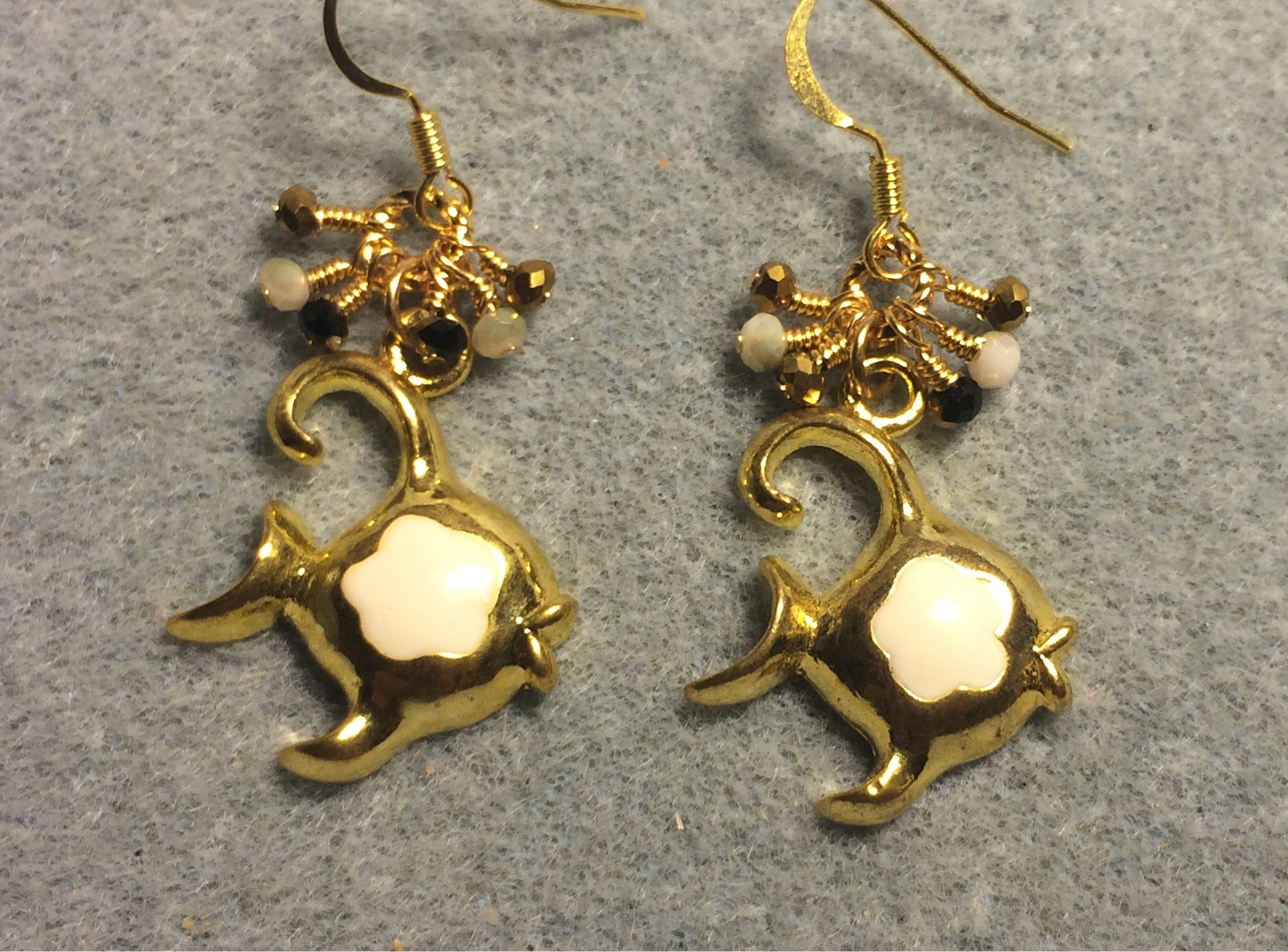Gold and off white enamel angelfish charm earrings adorned with tiny dangling gold and off white Chinese crystal beads.