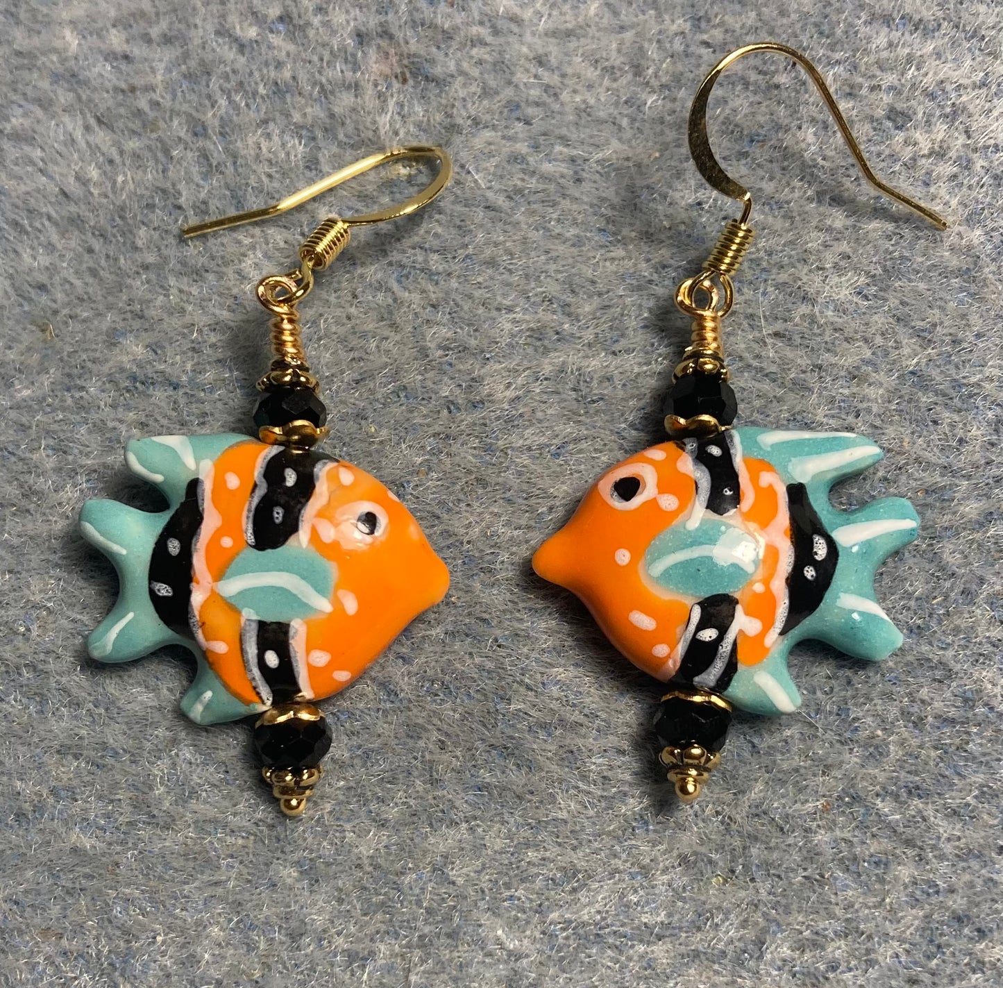Orange, turquoise, and black ceramic angelfish bead earrings adorned with black Chinese crystal beads.