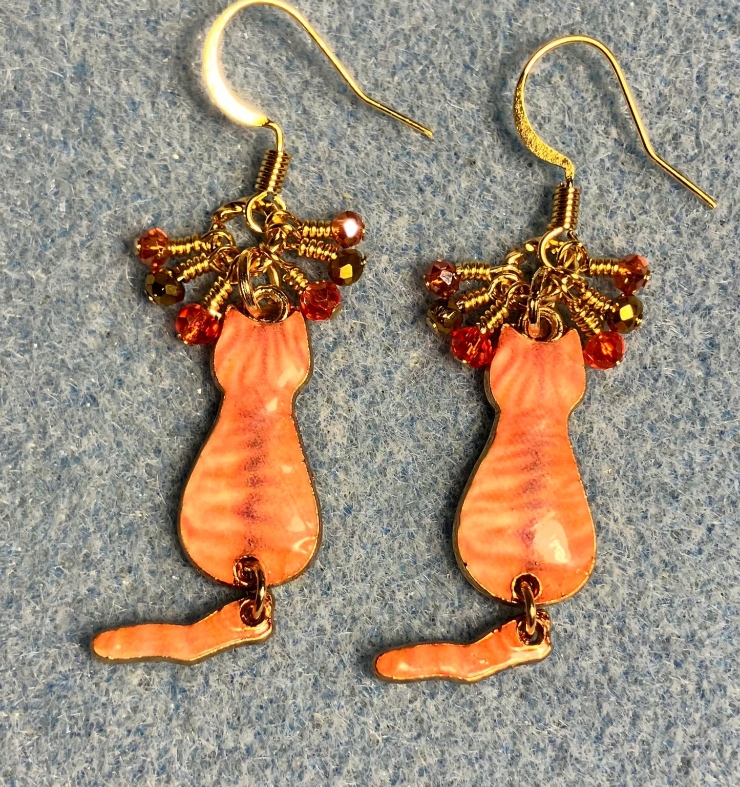 Orange and gold enamel tabby cat charm earrings adorned with tiny dangling orange and gold Chinese crystal beads.
