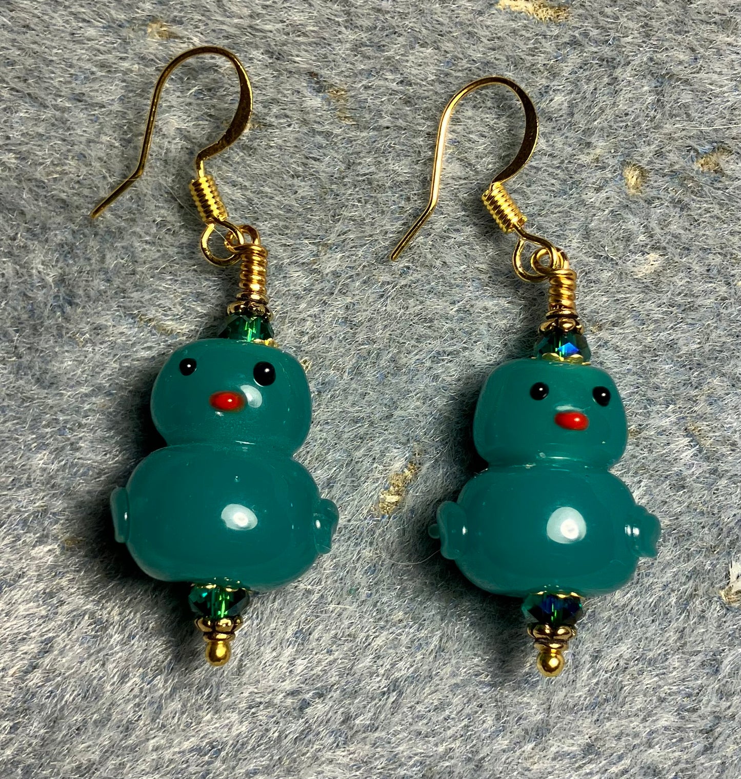 Opaque teal lamp work duck bead earrings adorned with teal Chinese crystal beads.
