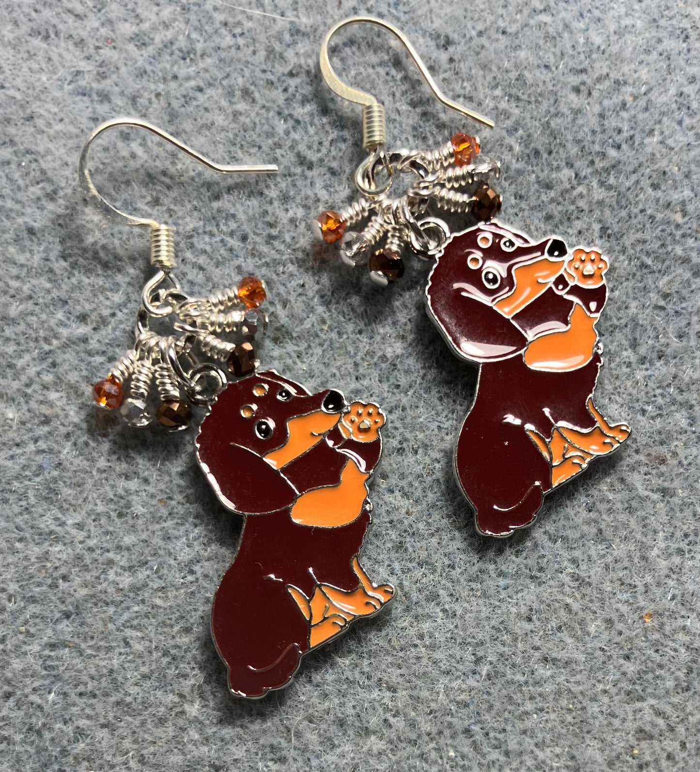 Large brown and orange enamel dachshund charm earrings adorned with tiny dangling brown, orange, and silver Chinese crystal beads.